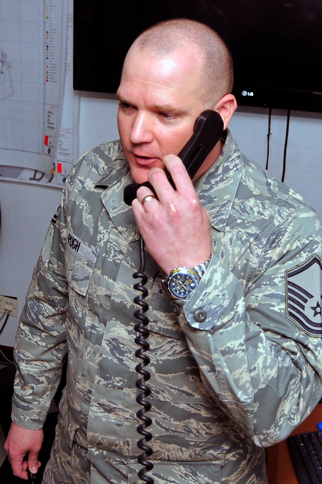 SOUTHWEST ASIA -Master Sgt. Samuel Pugh, 380th Expeditionary Operations Support Squadron weather flight chief, operates a pilot-to-meteoro service radio to give current weather conditions here Oct. 13, 2009. Sergeant Pugh is deployed from Tinker Air Force Base, Okla., and hails from Owasso, Okla. (U.S. Air Force photo/Tech. Sgt. Charles Larkin Sr)
