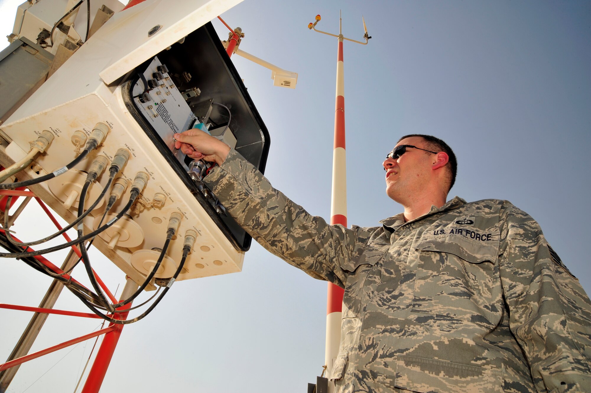 SOUTHWEST ASIA -Staff Sgt. Joshua Mace, 380th Expeditionary Operations Support Squadron weather forecaster, checks the fuses and desiccant on a fixed meteorological observation system here Oct. 13, 2009. Sergeant Mace is deployed from Beale Air Force Base, Calif., and hails from Eugene, Ore. (U.S. Air Force photo/Tech. Sgt. Charles Larkin Sr)