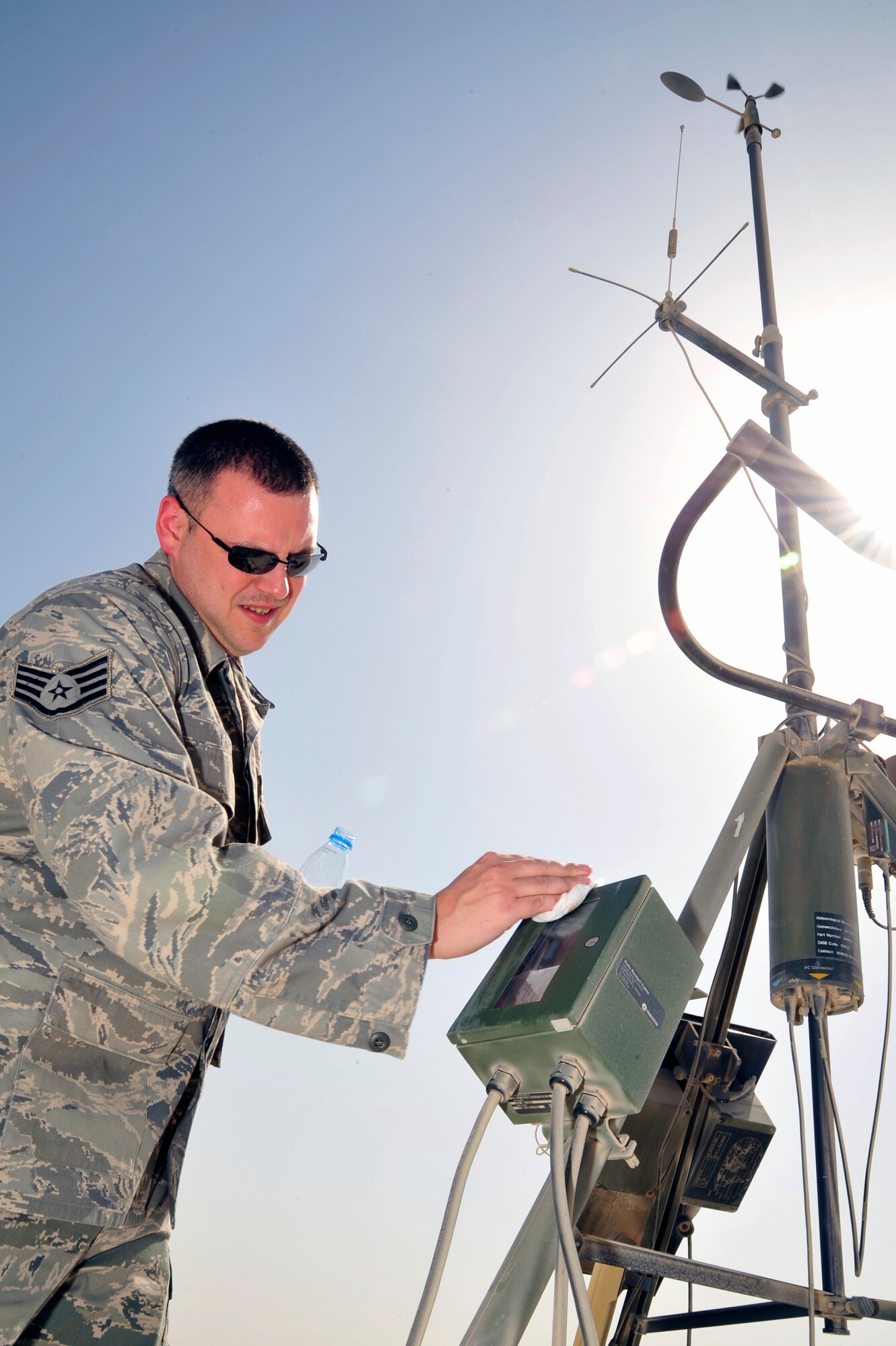 SOUTHWEST ASIA -Staff Sgt. Joshua Mace, 380th Expeditionary Operations Support Squadron weather forecaster, cleans the lens of a sensor on a tactical meteorological observation system here Oct. 13, 2009. Sergeant Mace is deployed from Beale Air Force Base, Calif., and hails from Eugene, Ore. (U.S. Air Force photo/Tech. Sgt. Charles Larkin Sr)