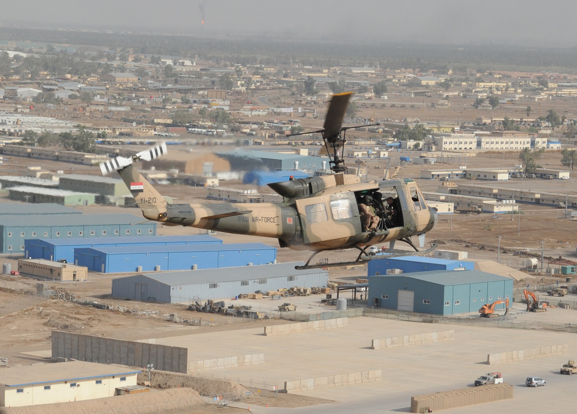 CAMP TAJI, Iraq -- Air Force instructors assigned to the 721st Air Expeditionary Advisory Squadron fly on a training mission here with their Iraqi students Oct. 8, 2009, as the Iraqi pilots perform aerial formation flying procedures. The U.S. Airmen train them on approaches, take-offs, landings and remote operations consisting of landing in unfamiliar landing zones. Air Force instructor pilots assigned to the 721st AEAS train, advise and assist Iraqi helicopter pilots around the clock, helping the Iraqis develop their air force. (U.S. Air Force photo/Tech. Sgt. Johnny L. Saldivar)

