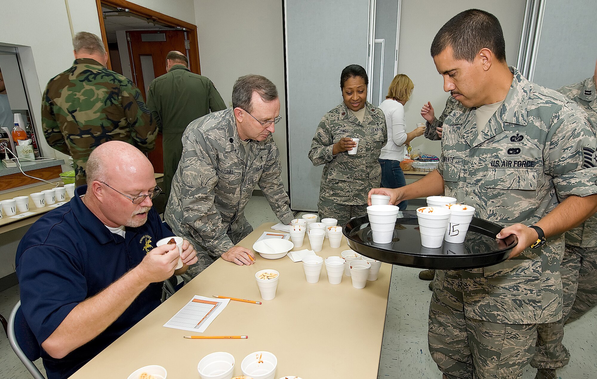 Tech. Sgt. Antonio Infante, 436th Airlift Wing Legal Office, served Rich Bowman, 436th AW Plans and Programs, and Chaplain (Lt. Col.) Timothy Sturgill, 436th AW Wing Chaplain, chili during the wing staff?s first Chili Cook-off at Chapel 2 Oct. 9. Chaplain Sturgill, Mr. Bowman, and Capt. Lanourra Phillips, 436th AW Legal Office, served as judges for the competition. (U.S. Air Force photo/ Jason Minto)