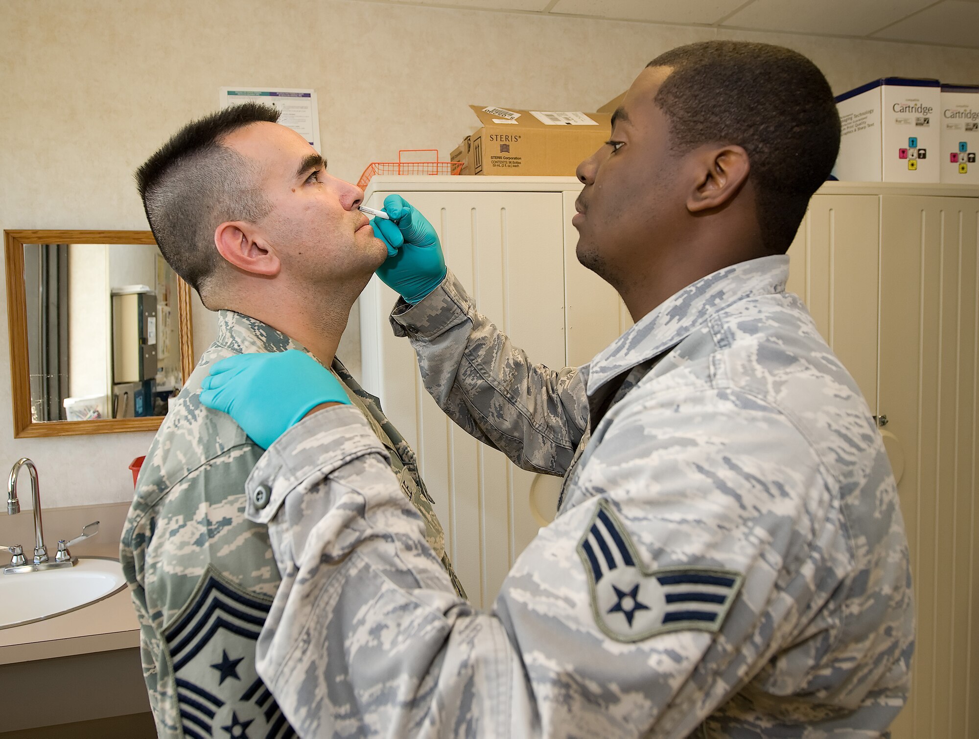(Left to right) Chief Master Sgt. John Evalle, 436th Airlift Wing command chief, receives the FluMist vaccination administered by Senior Airman Brandon Leonard, 436th Medical Operations Squadron medical technician. The 436th Medical Group will administer the mandatory seasonal influenza immunization to 436th AW active duty Airmen Oct. 20, 21 and 22 from 6 a.m. to 6 p.m. in conference room 2A on the second floor of the Base Clinic. (U.S. Air Force photo/ Jason Minto)