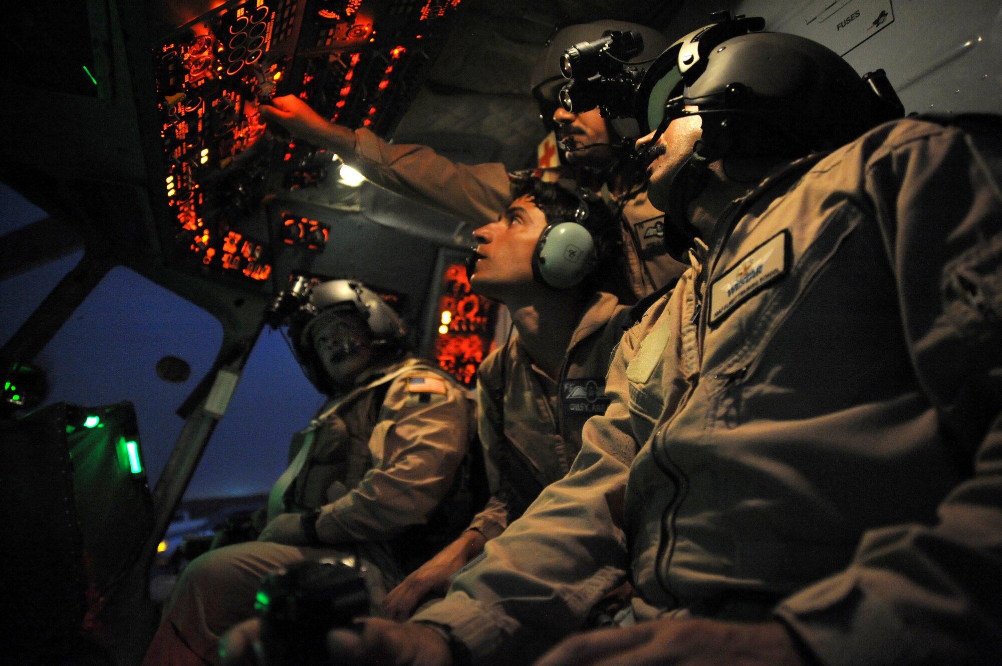 CAMP TAJI, Iraq -- Air Force Maj. Christopher Elam (left), 721st Air Expeditionary Advisory Squadron Mi-17 pilot, observes Iraqi air force pilots performing preflight procedures prior to a helicopter mission using night vision goggles Oct. 7, 2009. The major teaches them how to operate, preflight and maintain NVGs. U.S. Air Force instructor pilots assigned to the 721st AEAS train, advise and assist Iraqi helicopter pilots around the clock, helping them develop their own air force. Major Elam is deployed from Kirtland Air Force Base, N.M., and hails from Evanston, Ill.  (U.S. Air Force photo/Tech. Sgt. Johnny L. Saldivar)