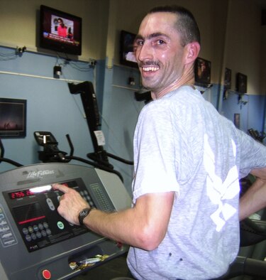 SOUTHWEST ASIA--Staff Sgt. Jason Blair, 387th Air Expeditionary Group emergency management craftsman, is all smiles after running 26.2 miles on a treadmill in a personal best time of 2 hours, 56 minutes at the 386th Air Expeditionary Wing fitness center Oct. 13, 2009. (U.S. Air Force/Courtesy photo) 