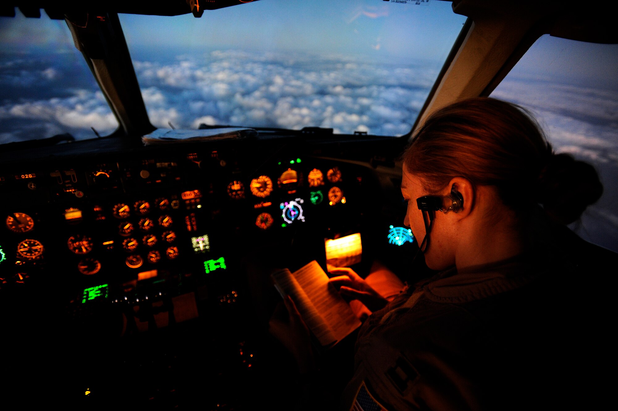 AFGHANISTAN - U.S. Air Force Capt. Sasha Heath, a KC-10A Extender pilot from the 908th Expeditionary Air Refueling Squadron, references flight material while flying over Afghanistan, Sept. 30, 2009.  Captain Heath is deployed from McGuire Air Force Base, N.J.  (U.S. Air Force photo/Staff Sgt. Michael B. Keller)