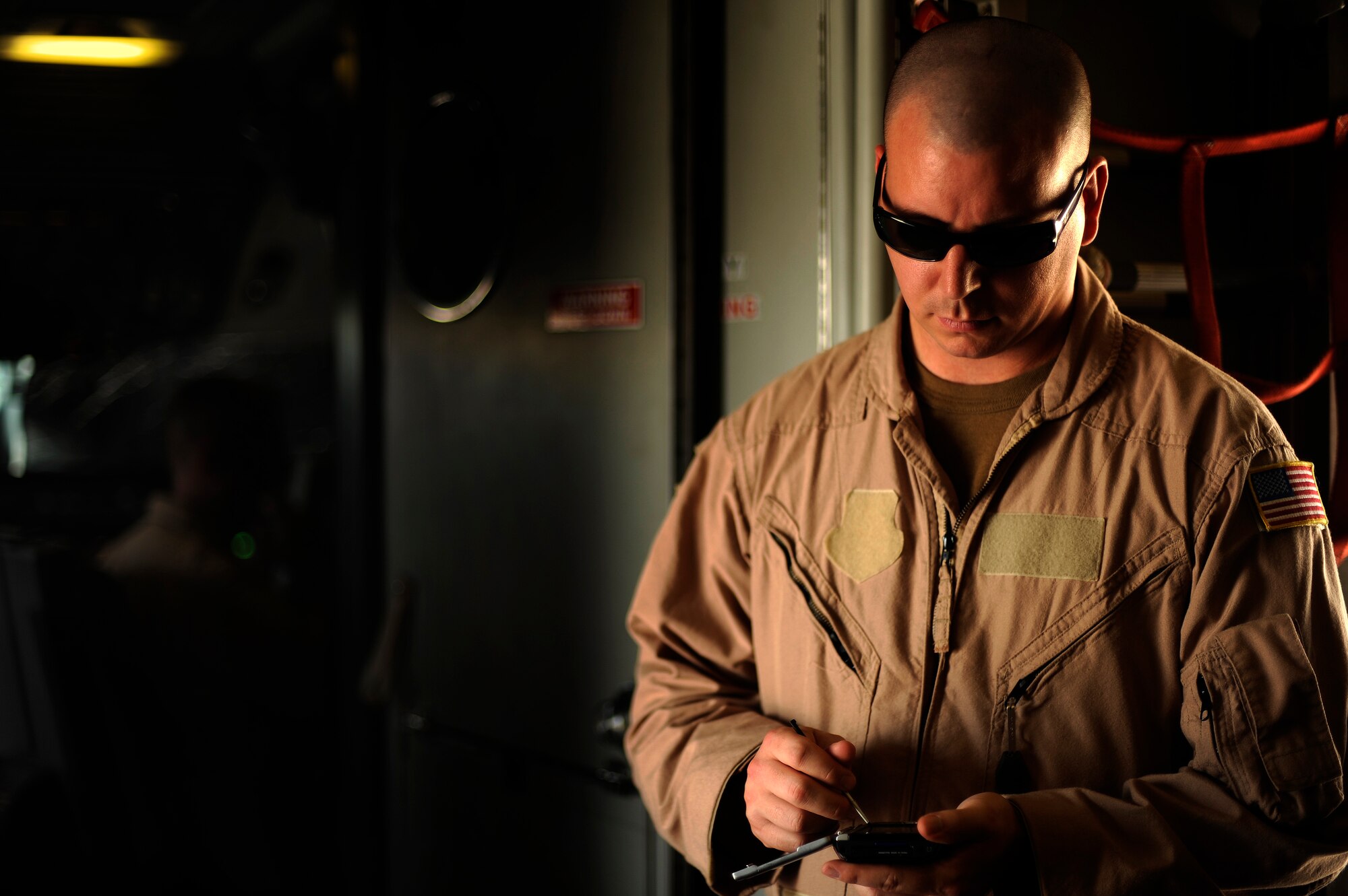 SOUTHWEST ASIA - U.S. Air Force Staff Sgt. Justin Taydus, a boom operator from the 908th Air Refueling Squadron, calculates fuel amounts onboard a KC-10A Extender prior to a refueling mission over Afghanistan, Oct. 2, 2009.  (U.S. Air Force photo/Staff Sgt. Michael B. Keller)