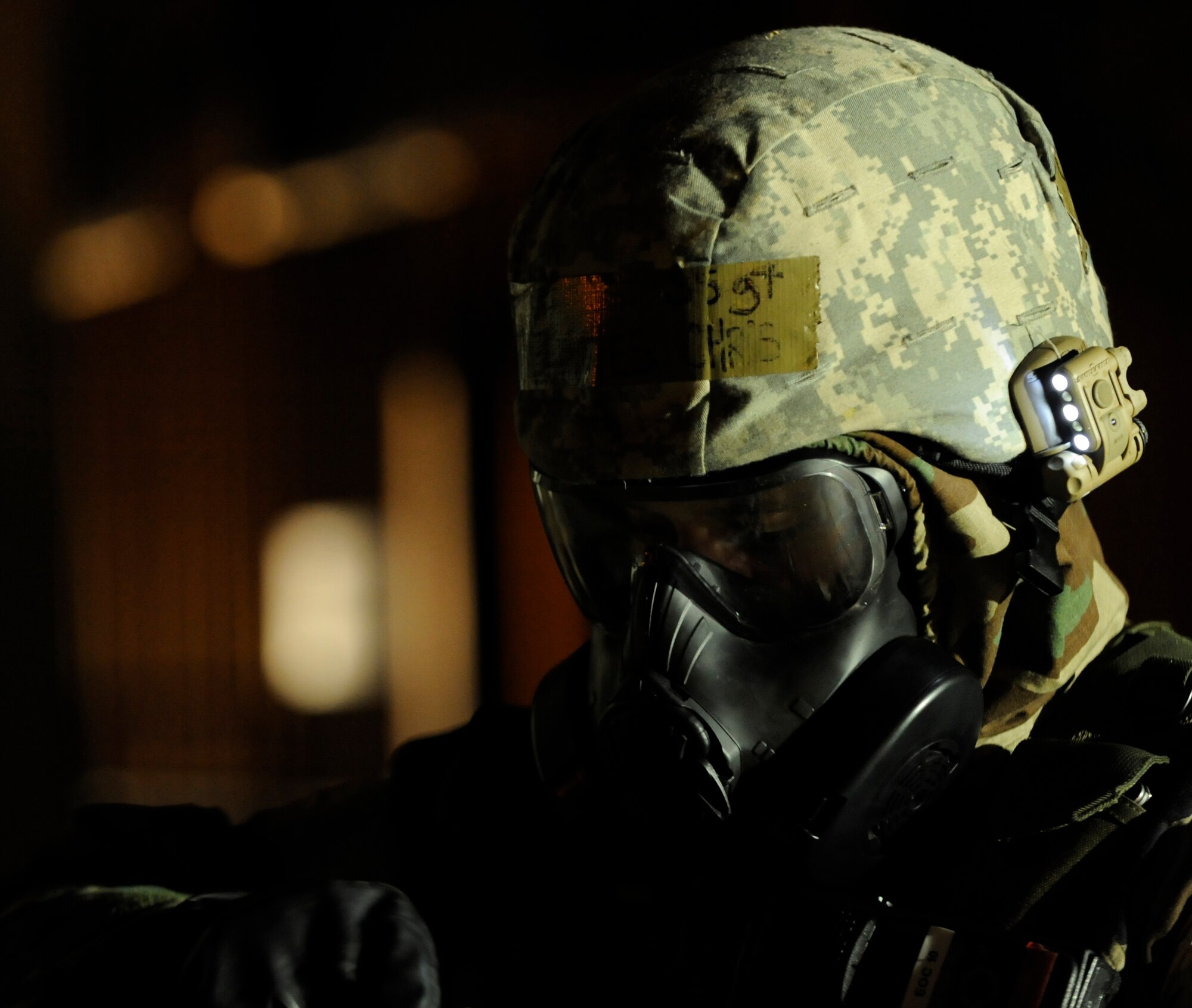 RAF MILDENHALL, England -- Staff Sgt. Christopher McFedries, 100th Civil Engineer Squadron, checks his decontamination kit while in his chemical suit during the Operational Readiness Inspection Oct. 13.  The inspection tests Airmen's abilities to operate in a wartime environment.  (U.S. Air Force photo/Staff Sgt. Christopher L. Ingersoll)
