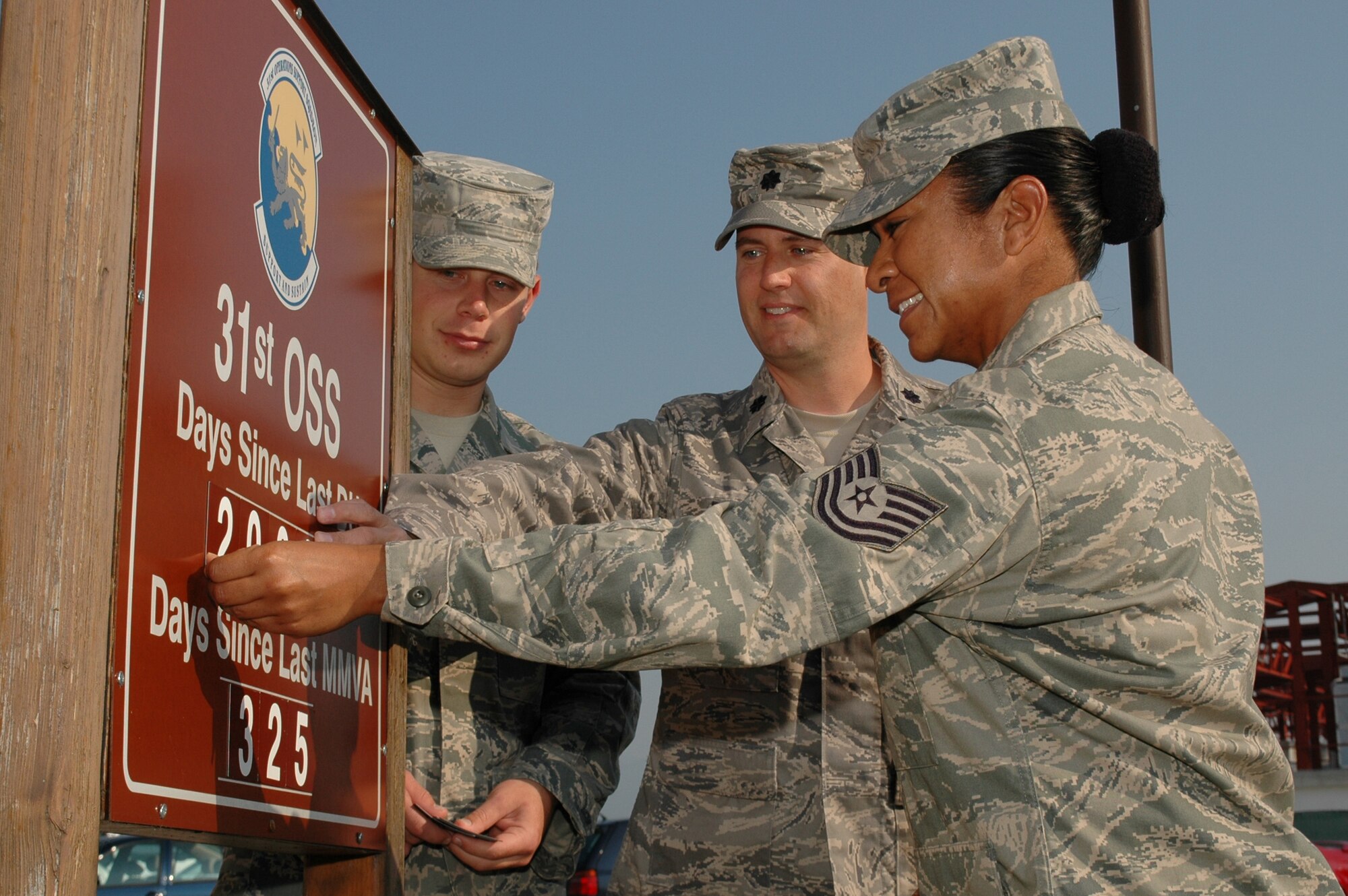 Lt. Col. Sean DeWitt, 31st Operations Support Squadron commander, Tech. Sgt. Gracey Martinez and Airman 1st Class Andrew Meyer update their unit's driving under the influence and major motor vehicle accident sign Sept. 28, 2009 to the 2,000th day since a DUI and 325th day since a MMVA at Aviano Air Base, Italy.  The commander had the two Airmen who've been assigned to the unit the longest, that being Sergeant Martinez, and the least, Airman Meyer, update the sign with him as some sort of passing of the torch in keeping safety at the forefront of everyone's mind in the unit. (U.S. Air Force photo/Tech. Sgt. Michael O'Connor)