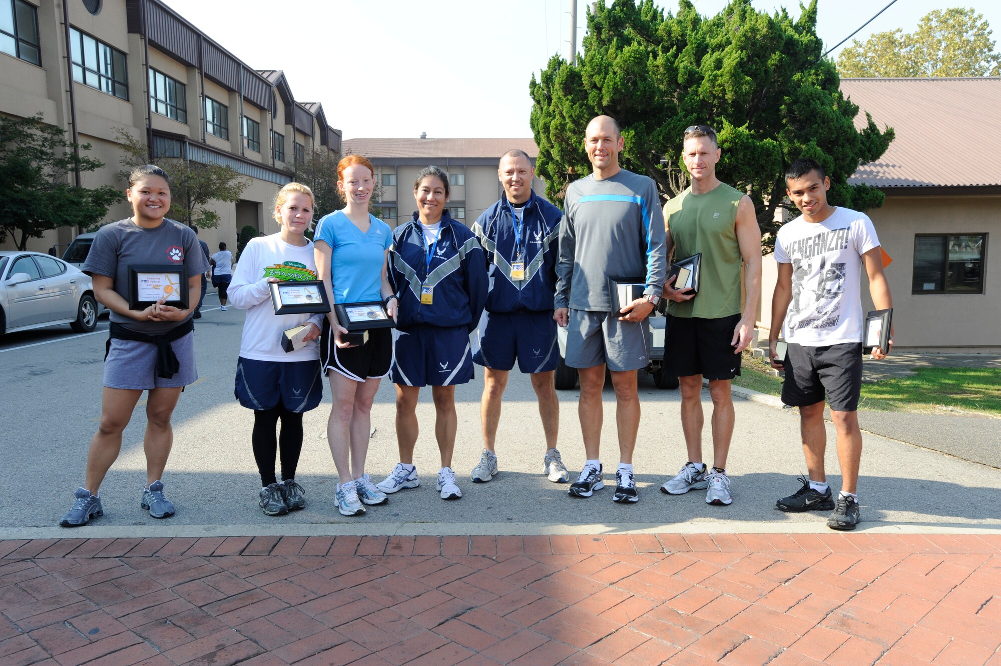 The first, second and third place winners of the female and male categories show off their awards after the  Combined Federal Campaign 5-K run at Osan Air Base, Republic of Korea, Oct. 10.  The CFC began Oct. 5 and runs through Dec. 4. The mission of the CFC is to promote and support philanthropy through a program that is employee focused, cost-efficient and effective in providing all federal employees the opportunity to improve the quality of life for all.  (U.S. Air Force photo/Senior Airman Stephenie Wade)

