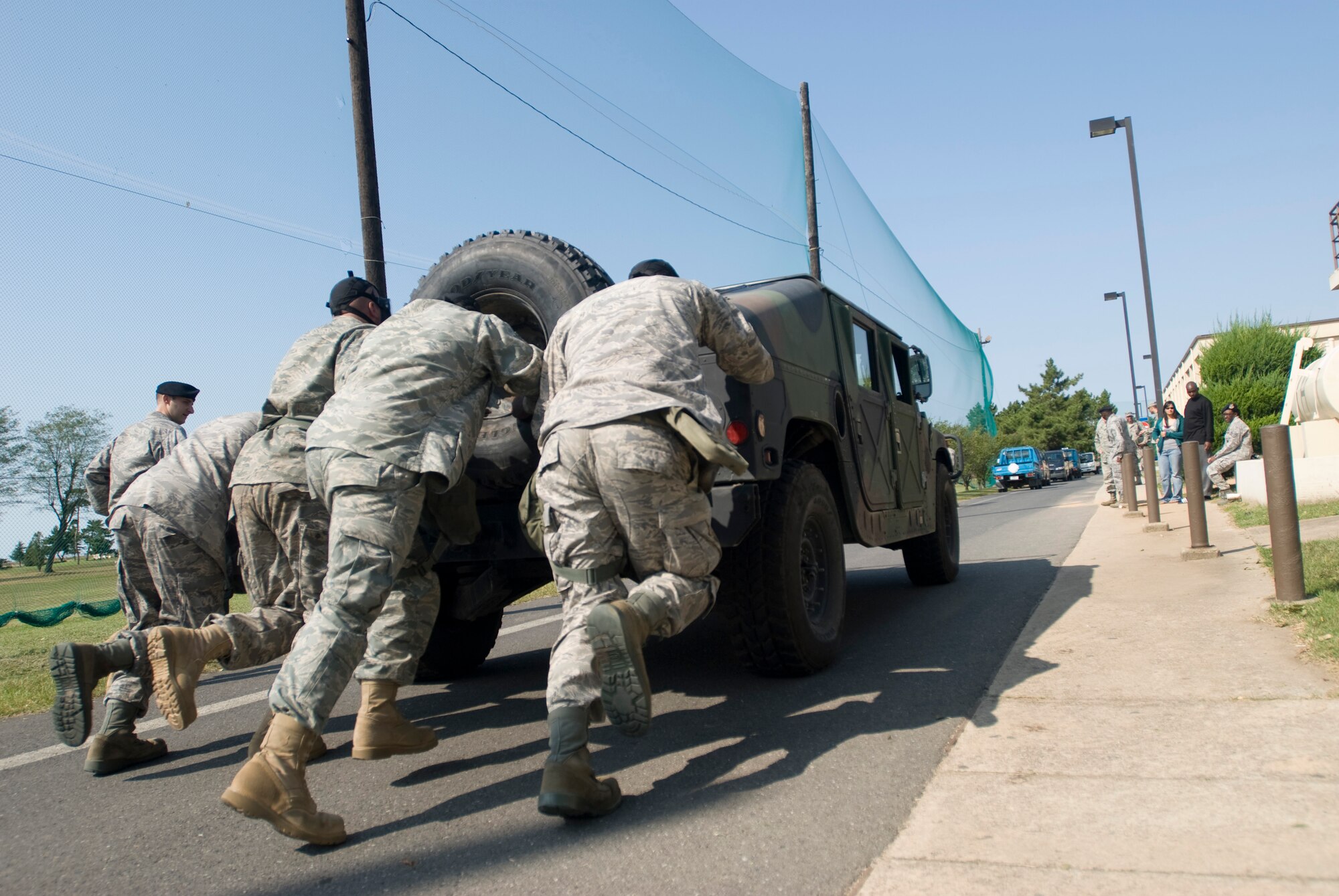 KUNSAN AIR BASE, Republic of Korea -- Tech. Sgt. Dion Thompson, Senior Airman Mark Alvarado, Tech. Sgt. Mathew Fenik and Airman Manuel Fralick, 8th Logistics Readiness Squadron, push a humvee during the 8th Security Forces Squadron Combat Challenge Oct.9.The Combat Challenge consisted of a four-member team working together to compete various activities.(U.S. Air Force photo/Senior Airman Jonathan Steffen)