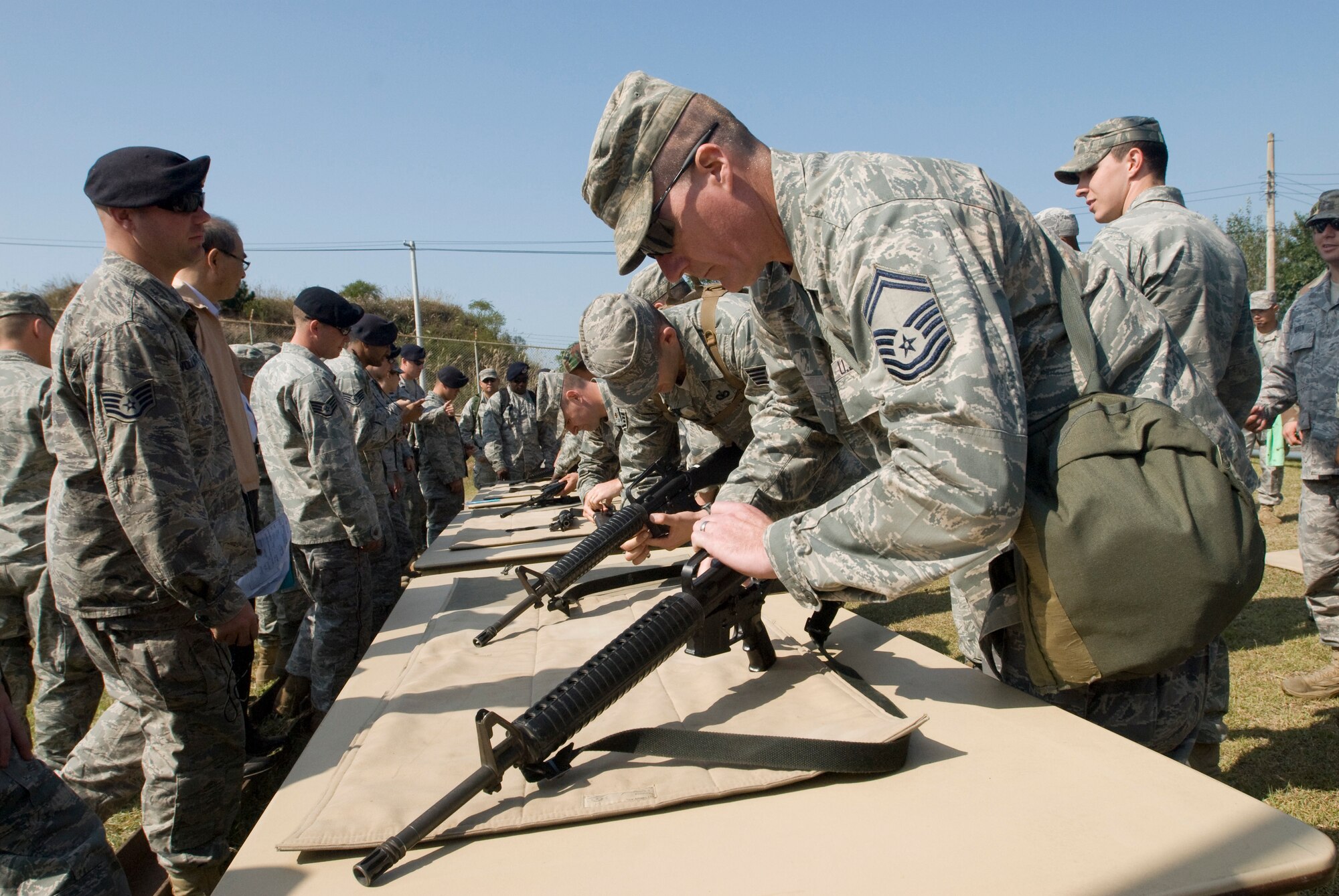 KUNSAN AIR BASE, Republic of Korea -- Kunsan members dissemble and reassemble an M-16 for the fastest time during the 8th Security Forces Squadron Combat Challenge Oct.9.The Combat Challenge consisted of a four-member team working together to compete various  activities. (U.S. Air Force photo/Senior Airman Jonathan Steffen)