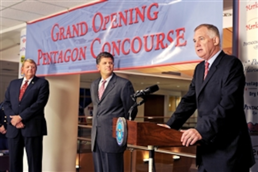 Deputy Defense Secretary William J. Lynn delivers remarks at the grand opening of the new concourse at the Pentagon, Oct. 14, 2009. William Davidson, far left, chairman of the Defense Department's Concessions Committee, and Michael Rhodes, center, acting director for Administration and Management, also participated in the ceremony. 