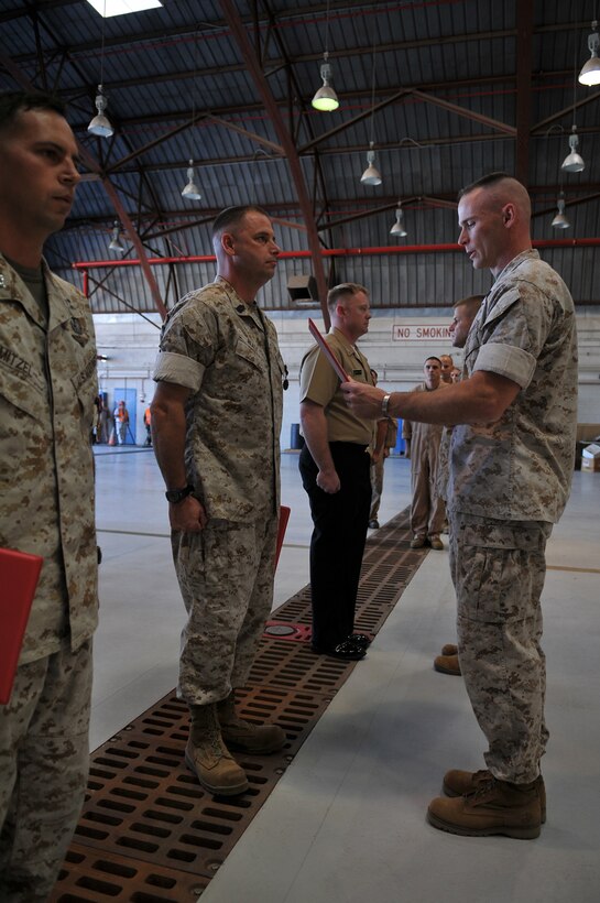 Headquarters and Headquarters Squadron sergeant major, Sgt. Maj. William Wiseman reads station Search and Rescue corpsman, Petty Officer 2nd Class Michael Skelton’s award citation for the Air Medal he received in the SAR hangar at the Marine Corps Air Station in Yuma, Ariz., Oct. 14, 2009. Skelton, along with SAR HH-1N Huey pilot, Capt. Sean Mitzel and SAR maintenance chief, Master Sgt. Russell Reale received the Air Medal for their actions, which led to the rescue of a fellow SAR air crewman during the Huey helicopter crash here in 2007.