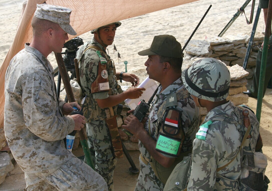 Sgt. Buddy I. Dagostino, an artillery forward observer with India Company, Battalion Landing Team, 3rd Battalion, 2nd Marine Regiment, 22nd Marine Expeditionary Unit, and native of Plymouth, Mass., coordinates fire plans with an Egyptian officer during a Combined-Arms Live-Fire Exercise conducted as part of Exercise Bright Star 2009 in Egypt, Oct. 14, 2009. The multinational exercise is designed to improve readiness, interoperability, and strengthen the military and professional relationships among U.S., Egyptian and participating forces. Bright Star is conducted by U.S. Central Command and held every two years. Elements of the 22nd MEU are currently are participating in the multi-national exercise while serving as the theater reserve force for U.S. Central Command.::r::::n::(Official Marine Corps Photo by Cpl. Theodore W. Ritchie)::r::::n::