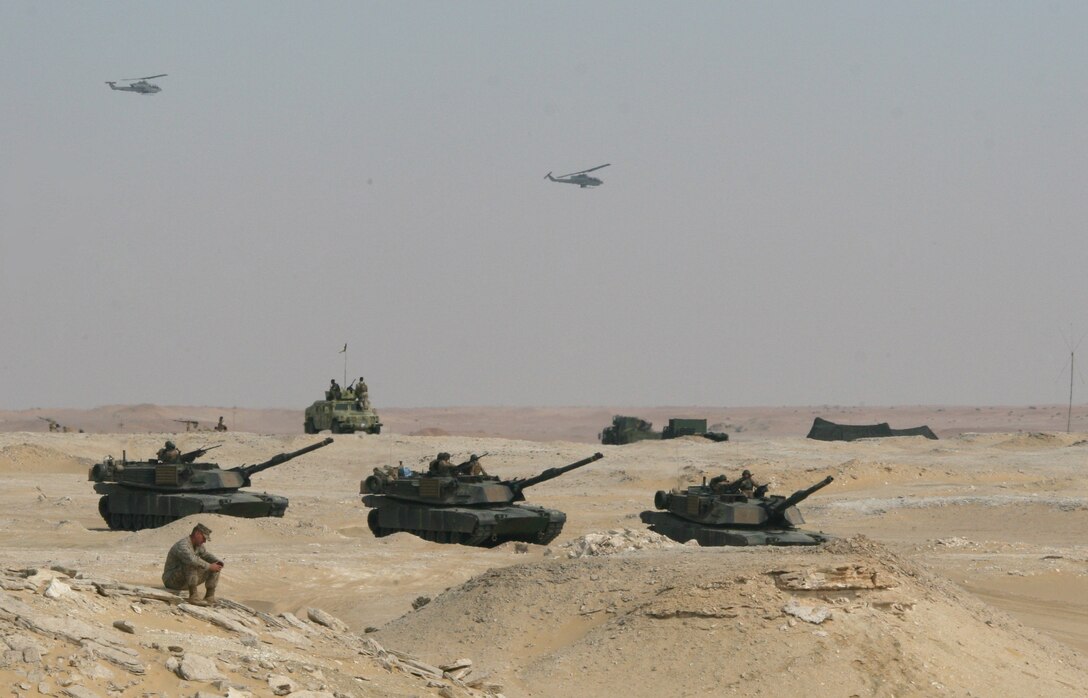 Three M1-A1 Abrams Main Battle Tanks attached to India Company, Battalion Landing Team, 3rd Battalion, 2nd Marine Regiment, 22nd Marine Expeditionary Unit; two AH-1W Super Cobras from Marine Medium Tiltrotor Squadron 263 (Reinforced), 22nd MEU; and Kuwaiti Humvees are staged for a Combined-Arms Live-Fire Exercise conducted as part of Exercise Bright Star 2009 in Egypt, Oct. 14, 2009. The multinational exercise is designed to improve readiness, interoperability, and strengthen the military and professional relationships among U.S., Egyptian and participating forces. Bright Star is conducted by U.S. Central Command and held every two years. Elements of the 22nd MEU are currently are participating in the multi-national exercise while serving as the theater reserve force for U.S. Central Command.::r::::n::(Official Marine Corps Photo by Cpl. Theodore W. Ritchie)::r::::n::