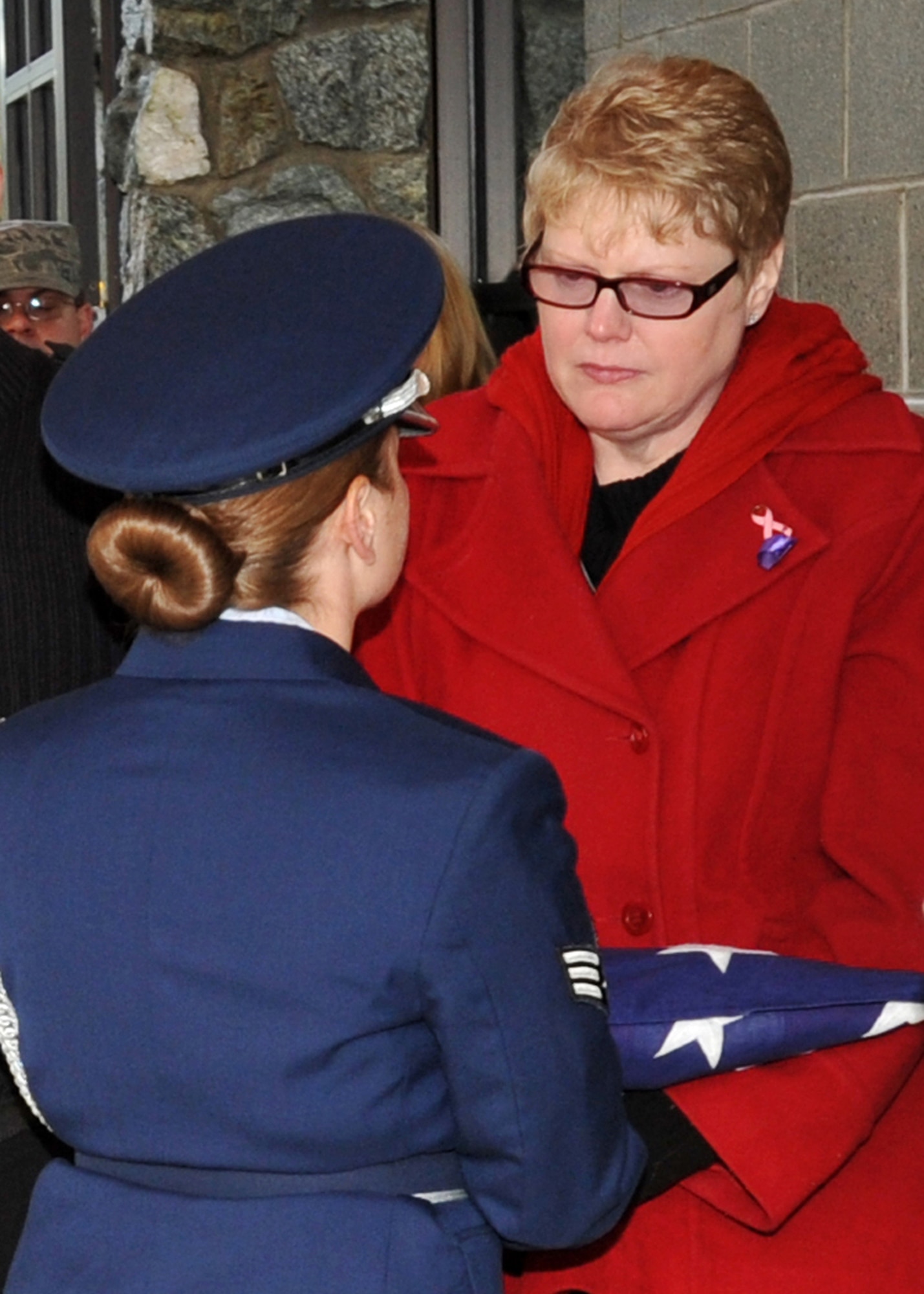 FORT RICHARDSON, Alaska -- A member of the Elmendorf Air Force Base Honor Guard hands a folded flag over to the Sharon Buren, mother of Staff Sgt. Shawn Rankin, during the funeral service for Rankin, at the Fort Richardson National Cemetery. Rankin of Anchorage, Alaska, was assigned to the 56th Aircraft Maintenance Squadron and served as an F-16 Fighting Falcon crew chief at Luke Air Force Base, Ariz. (U.S. Air Force photo/Senior Airman Laura Turner)