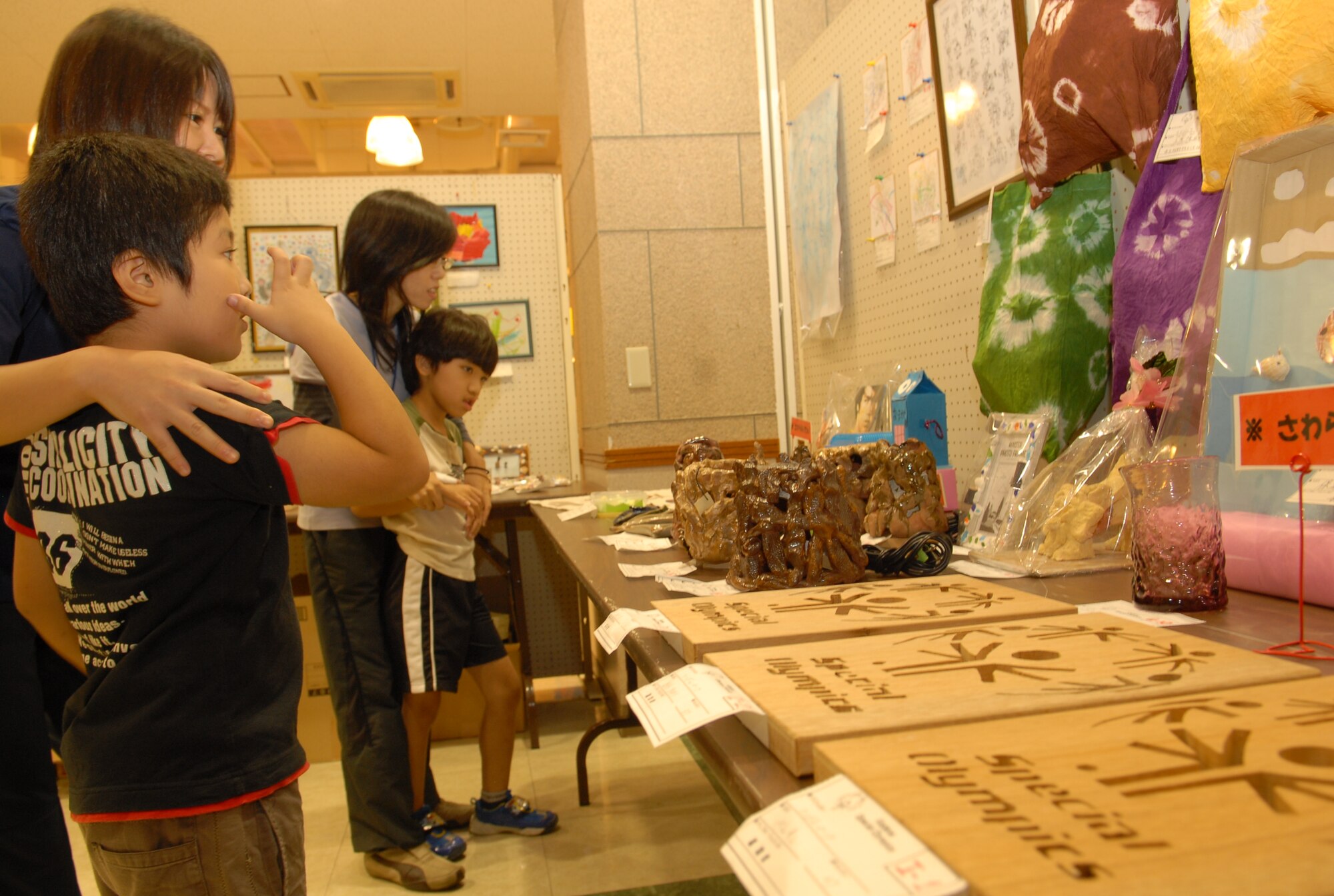 Guests enjoy the art at the Kadena Special Olympics Art Exhibit Oct. 15. More than 300 works of art created by special needs students from elementary and junior high schools in Okinawa City, Nago City, Kadena Town, and Chatan were on display. (U.S. Air Force Photo/1st Lt. Joe Kreidel)