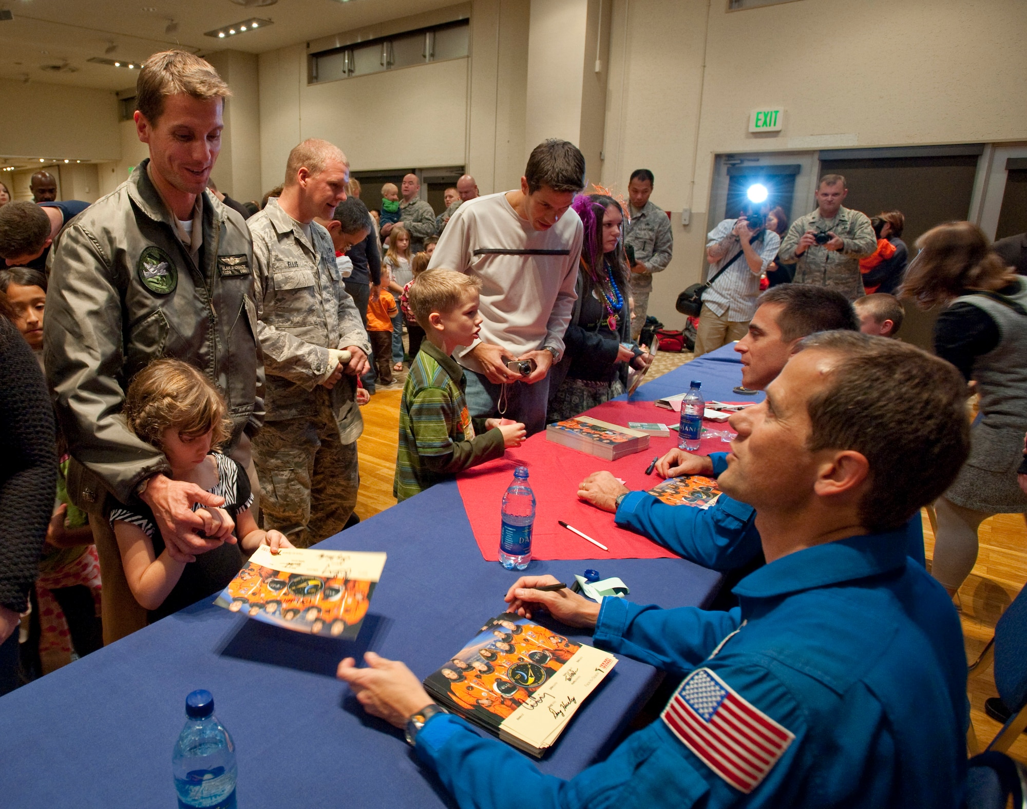 NASA astronauts Tom Marshburn and Chris Cassidy sign autographs and talk to residents of Misawa Air Base at the Mokuteki Community Center Oct. 15. The crew flew on Space Shuttle Endeavour's 23rd mission to the International Space Station in July. (U.S. Air Force photo/Staff Sgt. Samuel Morse)