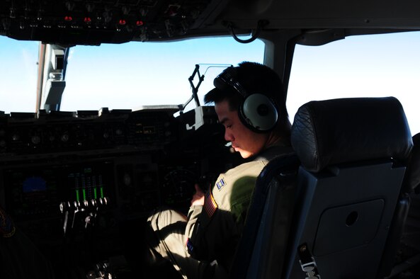 Pilot Capt. John Ma, 535th Airlift Squadron, 15th Airlift Wing, prepares to land a C-17 Globemaster III based out of Hickam Air Force Base, Hawaii, after more than 10 hours of flying from Kadena Air Base, Japan, through U-Tapao, Thailand and finally to Agra Air Base, India. The crew,, more than 40 passengers and its cargo arrived in country as part of exercise Cope India, a humanitarian assistance disaster relief mission which stars Oct. 19. (U.S. Air Force photo by Capt. Genieve David/ RELEASED)