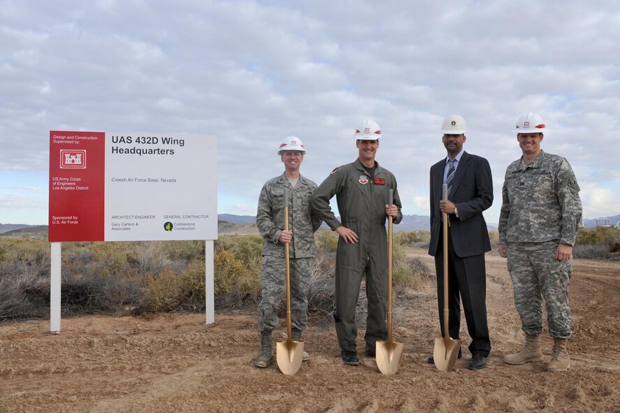 CREECH AFB, Nev. – From left to right, Capt. Raymond Swallow, 432d Wing Construction Project Manager, Col. Pete Gersten 432d Wing Commander and 432d Air Expeditionary Wing Commander, Mr. Benden Parker President and Chief Executive Officer of Cobblestone Construction, and Army Capt. Ben Ashton, U.S. Army Corps of Engineers, Los Angeles district, prepare to break ground for the new 432d Wing Headquarters building here, Oct. 7. (U.S. Air Force photo/Tech Sgt. Michael R. Holzworth)