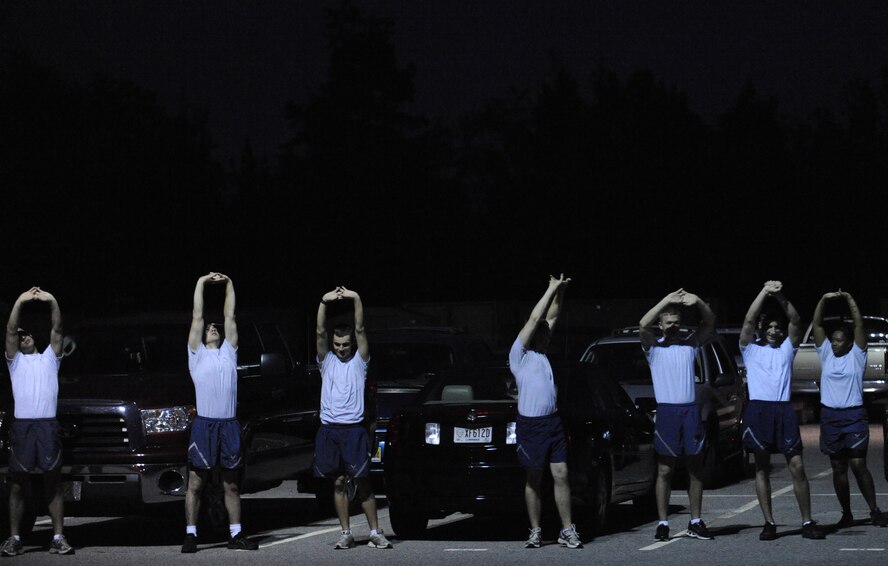 MOODY AIR FORCE BASE, Ga. -- Members of the 820th Security Forces Group, 93rd Air Ground Operations Wing, a tenant wing on Moody, and current Airmen Leadership School students stretch before the Airman 1st Class Leebernard Chavis memorial workout here Oct. 14. The workout includes an extended push-up exercise, a one-mile run, squat thrusts and other intensive exercises. (U.S. Air Force photo by Staff Sgt. Elizabeth Rissmiller)