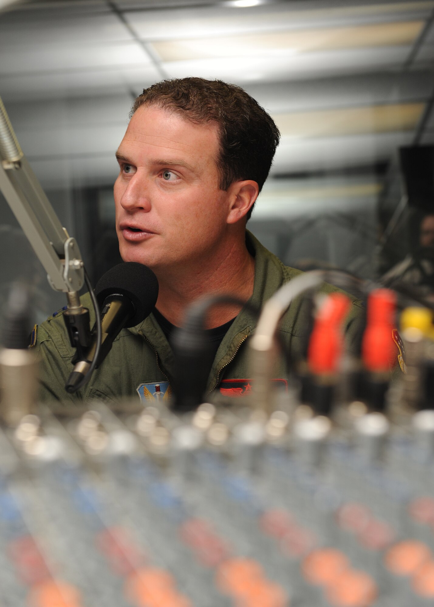 ALAMOGORDO, N.M. -- Capt. August Pfluger, 49th Fighter Wing Open House director, speaks during a radio show on KRSY here Oct. 8. The purpose of the radio show was to broadcast information about the upcoming Open House at Holloman Air Force Base, N.M., scheduled for Oct. 24. The day-long Open House will showcase Holloman assets as well as Canadian and German air force aircraft. (U.S. Air Force photo by Senior Airman Rachel Kocin)