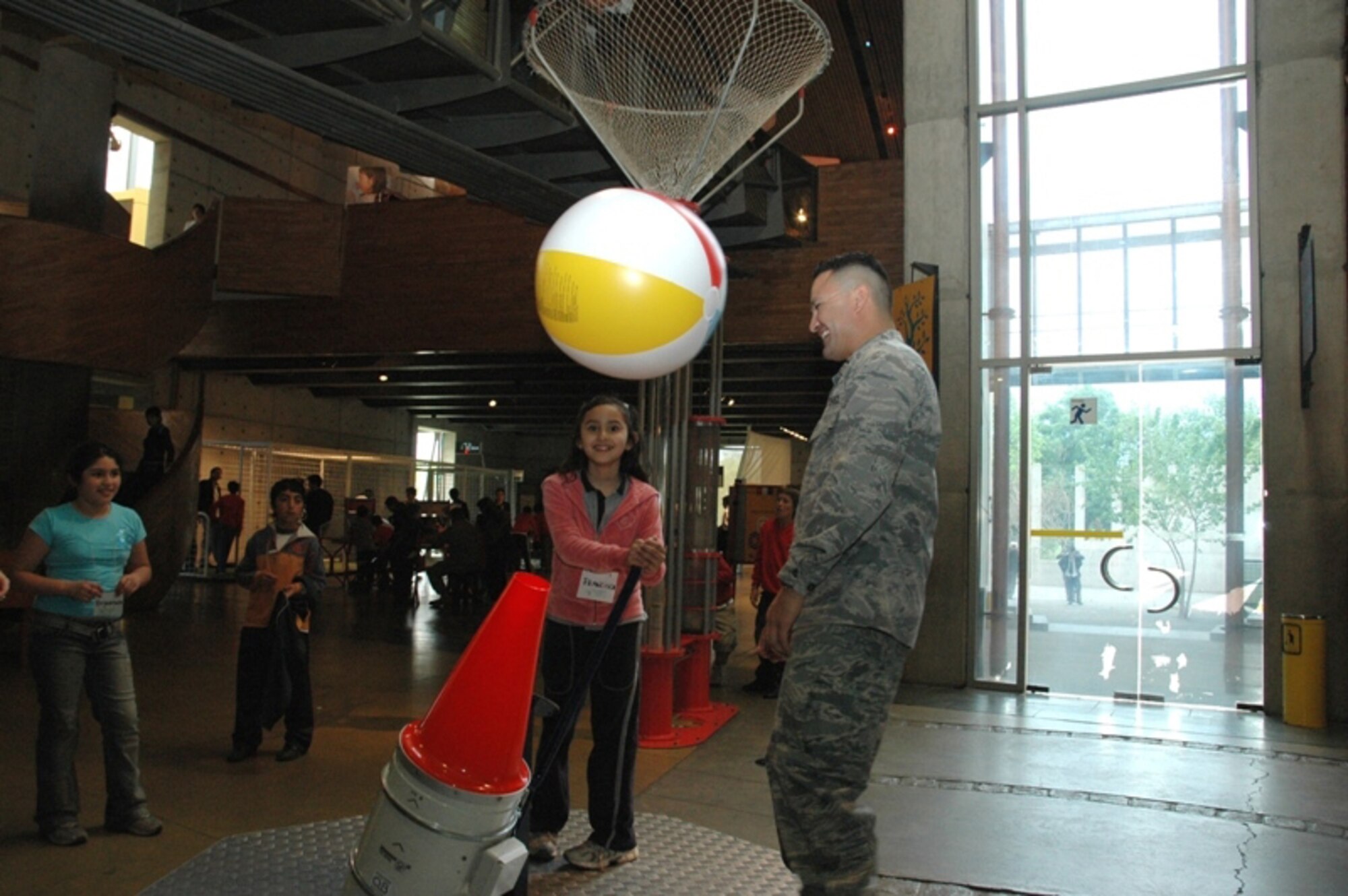 SANTIAGO, Chile -- Capt Randy Saldivar, a public affairs officer with the Texas Air National Guard, assists a young girl with a display at the Museo Interactivo Mirador, an interactive science museum in Santiago, Chile.  Airmen were in Santiago, Chile conducting a subject matter exchange with the Chilean Air Force as part of Air Forces Southern's ongoing Cooperation Team-One initiative and decided to use their first day in country to sponsor a group of at-risk children during a trip to a local science museum. (Courtesy photo)
