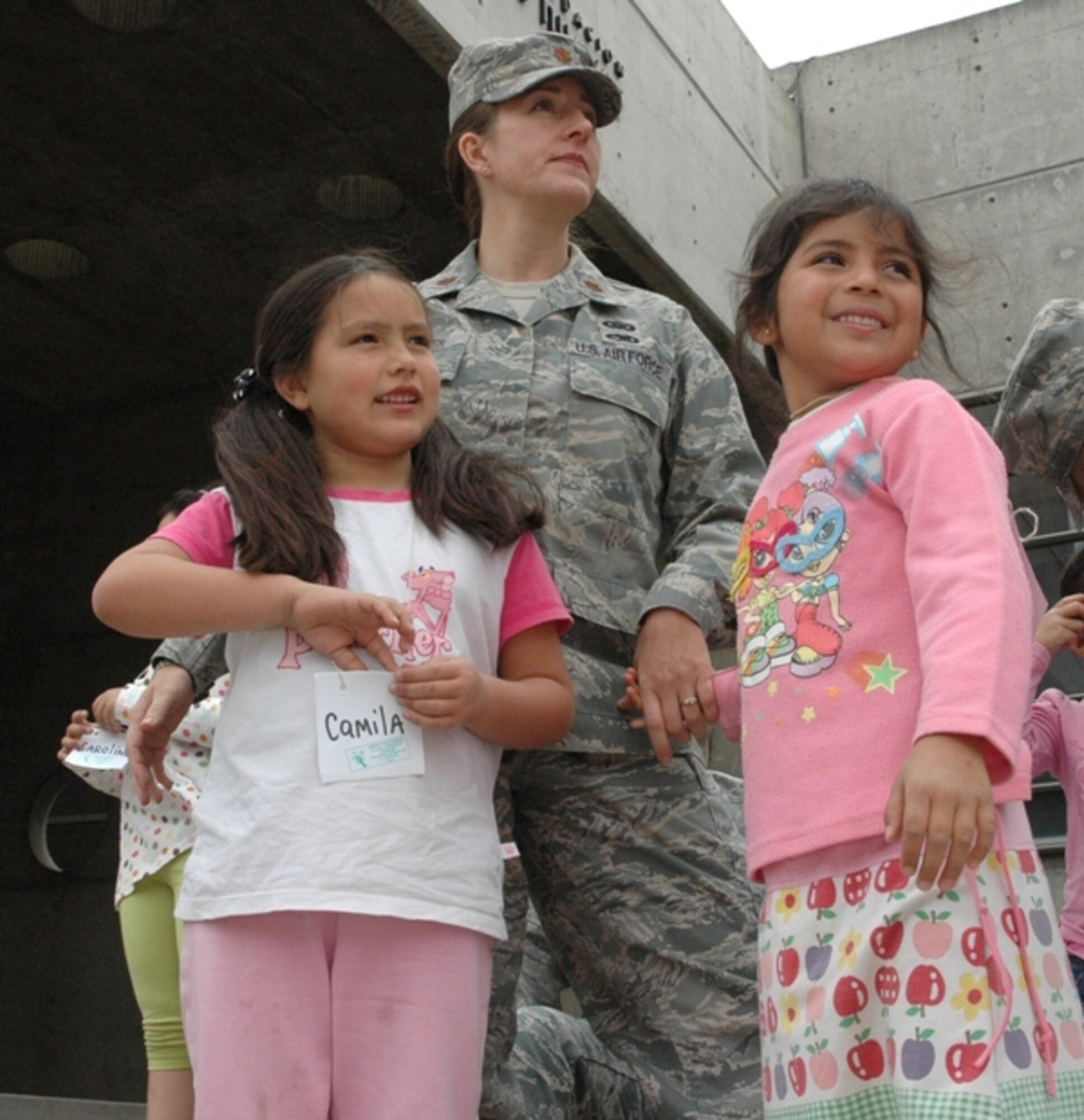 SANTIAGO, Chile -- Maj. Jana Nyerges, a member of Air Forces Southern participating in a subject matter exchange with the Chilean Air Force in Santiago, Chile, waits with children from the Centro Comunitario Angels, or 'Angels Community Center,' outside the Museo Interactivo Mirador prior to sponsoring the children's admission to the science exhibits.  Airmen decided to use their first day in Chile to sponsor a group of at-risk children during a visit to the museum. (Courtesy photo)