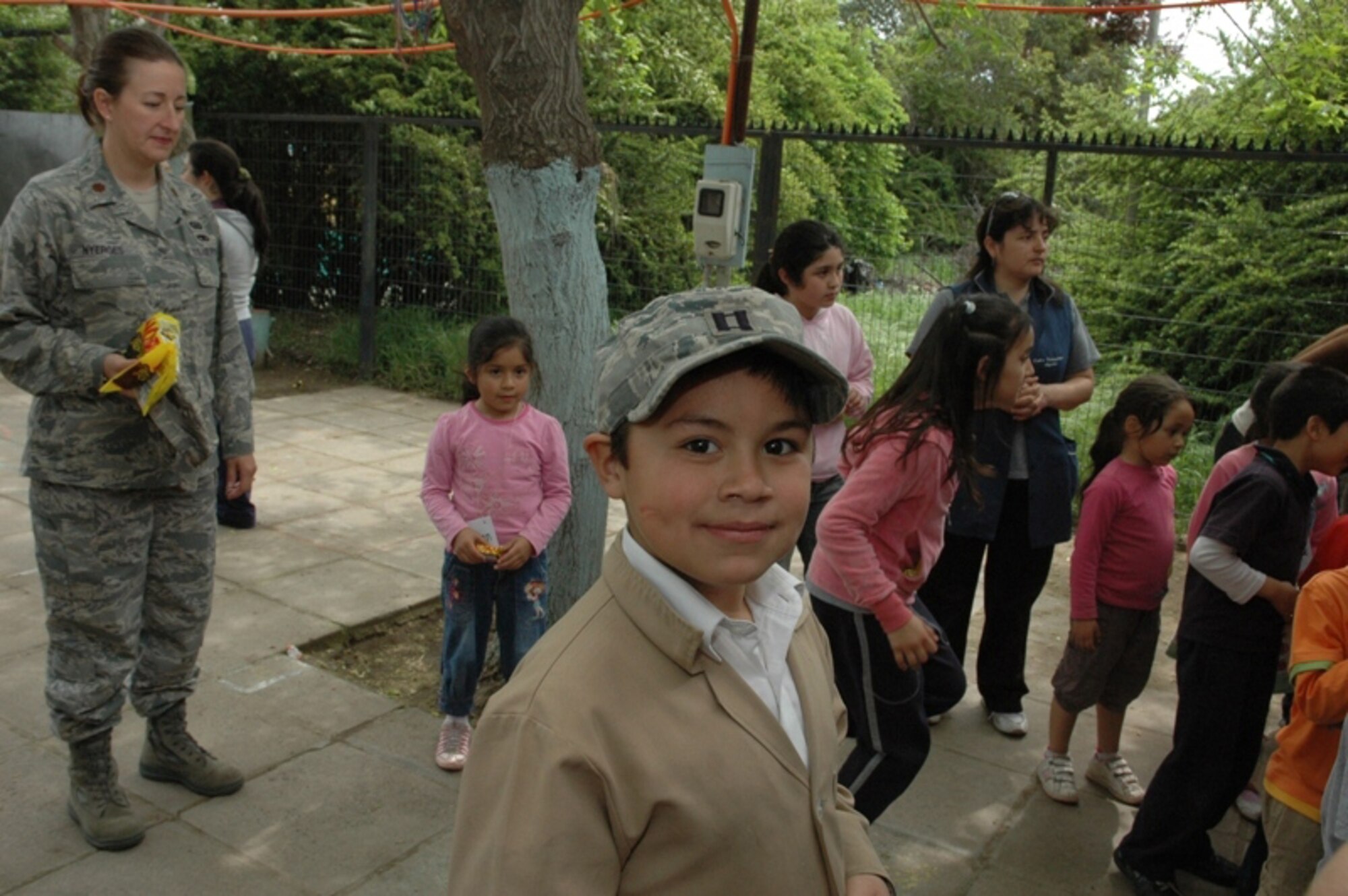 SANTIAGO, Chile -- Children from the Centro Comunitario Angels, or 'Angels Community Center,' gather in the school's courtyard to play with Airmen during a surprise visit.  Airmen were in Santiago, Chile conducting a subject matter exchange with the Chilean Air Force as part of Air Forces Southern's ongoing Cooperation Team-One initiative and decided to use their first day in country to sponsor a group of at-risk children during a trip to a local science museum. (Courtesy photo)