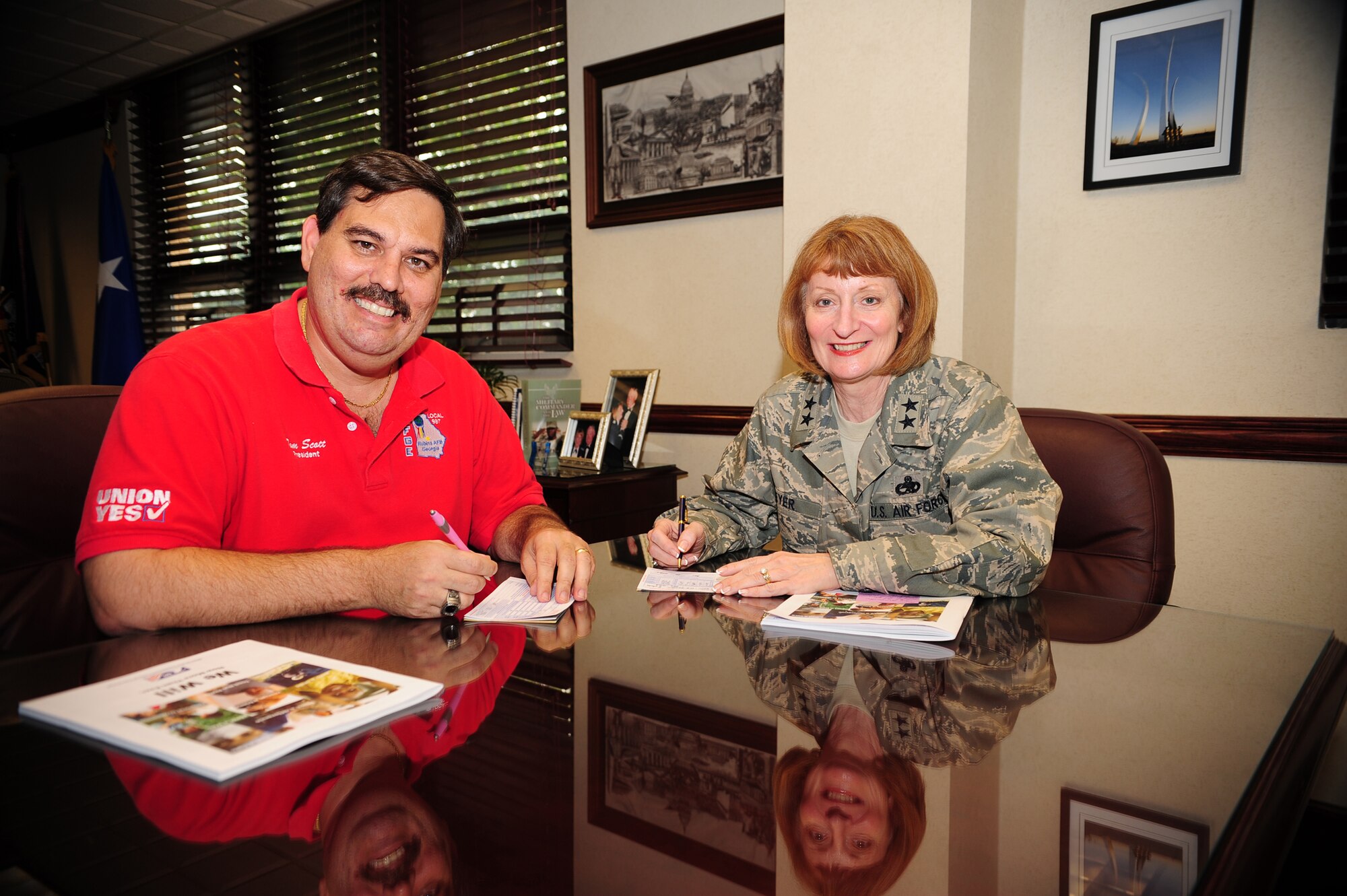 Tom Scott, AFGE Local 987 president and Maj. Gen. Polly A Peyer, WR-ALC commander, sign their pledge cards. U. S. Air Force photo by Ray Crayton