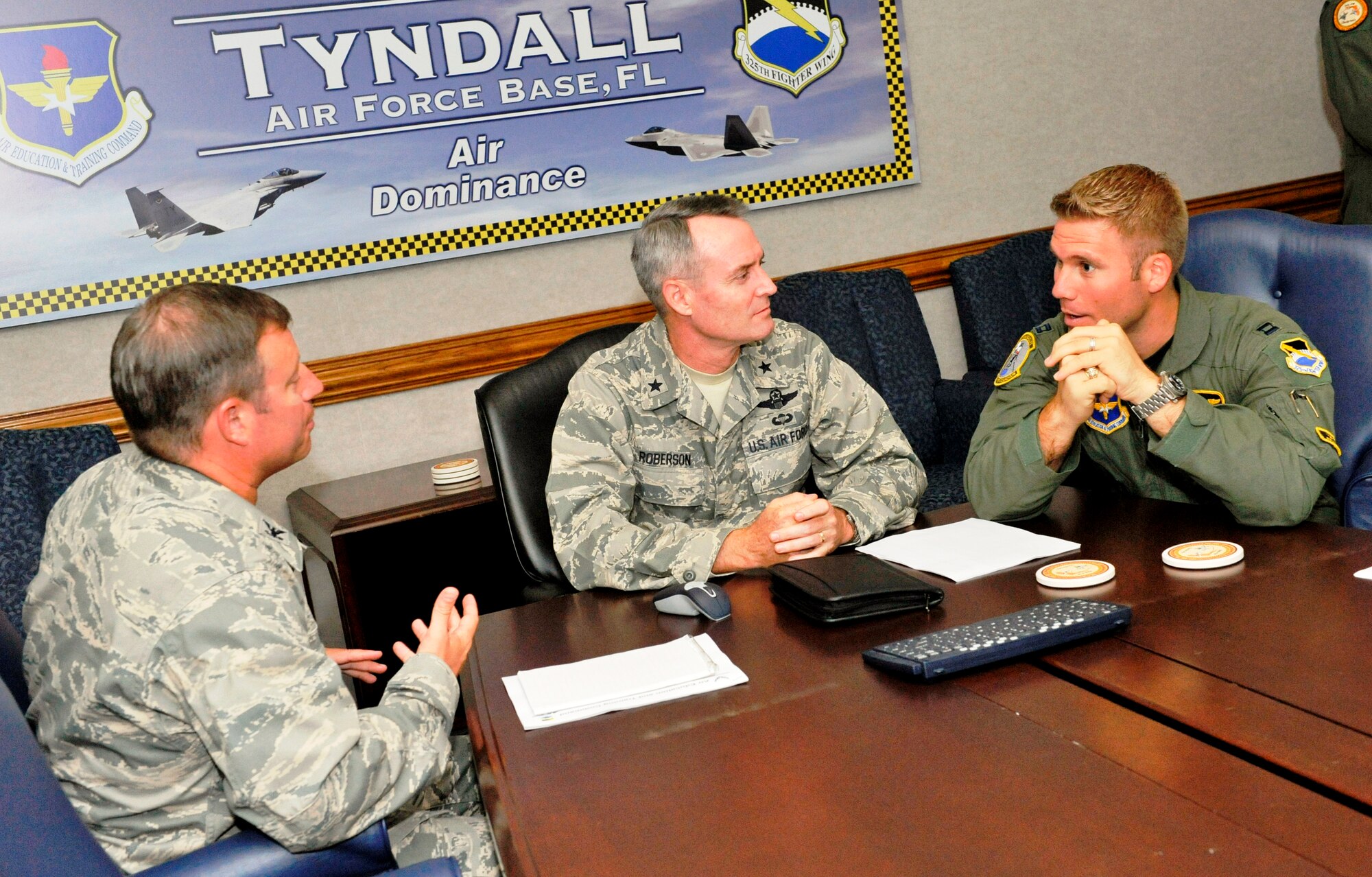 Capt. David Anderson, 2nd Fighter Squadron flight commander and F-15C instructor pilot, shadows Brig. Gen. Darryl Roberson, 325th Fighter Wing commander, during the commander’s staff meeting here Oct. 13.  Captain Anderson directly supervises 13 assigned F-15 Instructor Pilots and oversees all aspects of training for 40 upgrading pilots annually.  Captain Anderson spent the day with General Roberson as part of the Commander’s Shadow Program.  He has served seven years in the military and is a native of Bellville, Texas.  (U.S. Air Force photo/Jonathan Gibson)  
