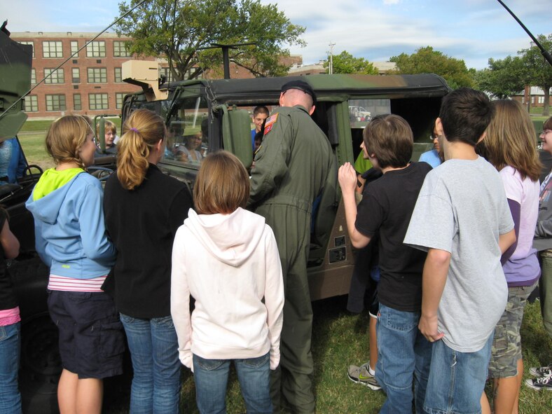 TSgt Mark Wall, from the 184 Security Forces Squadron,  shows students from Robinson Middle School a military humvee on September 30th at the Meet Your Locals Hereoes event.