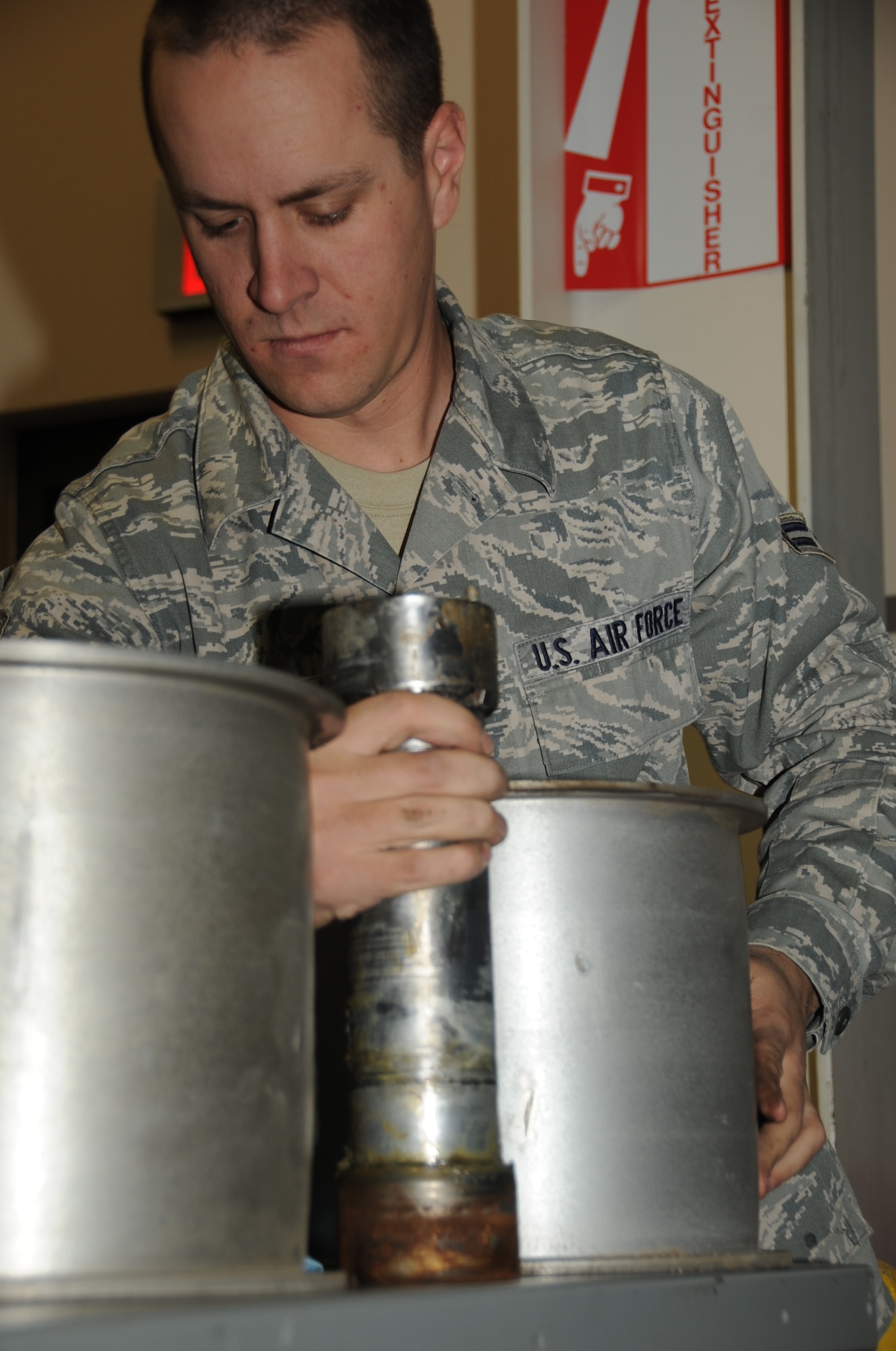 ELLSWORTH AIR FORCE BASE, S.D. -- Airman 1st Class Christopher Bratton, 28th Civil Engineer Squadron electrical power production apprentice, arranges roller sheaves after removing them from a mobile aircraft arresting system, Oct. 15.  The roller sheaves, when in place, run a large belt through the MAAS. (U.S Air Force photo/Airman 1st Class Anthony Sanchelli)
