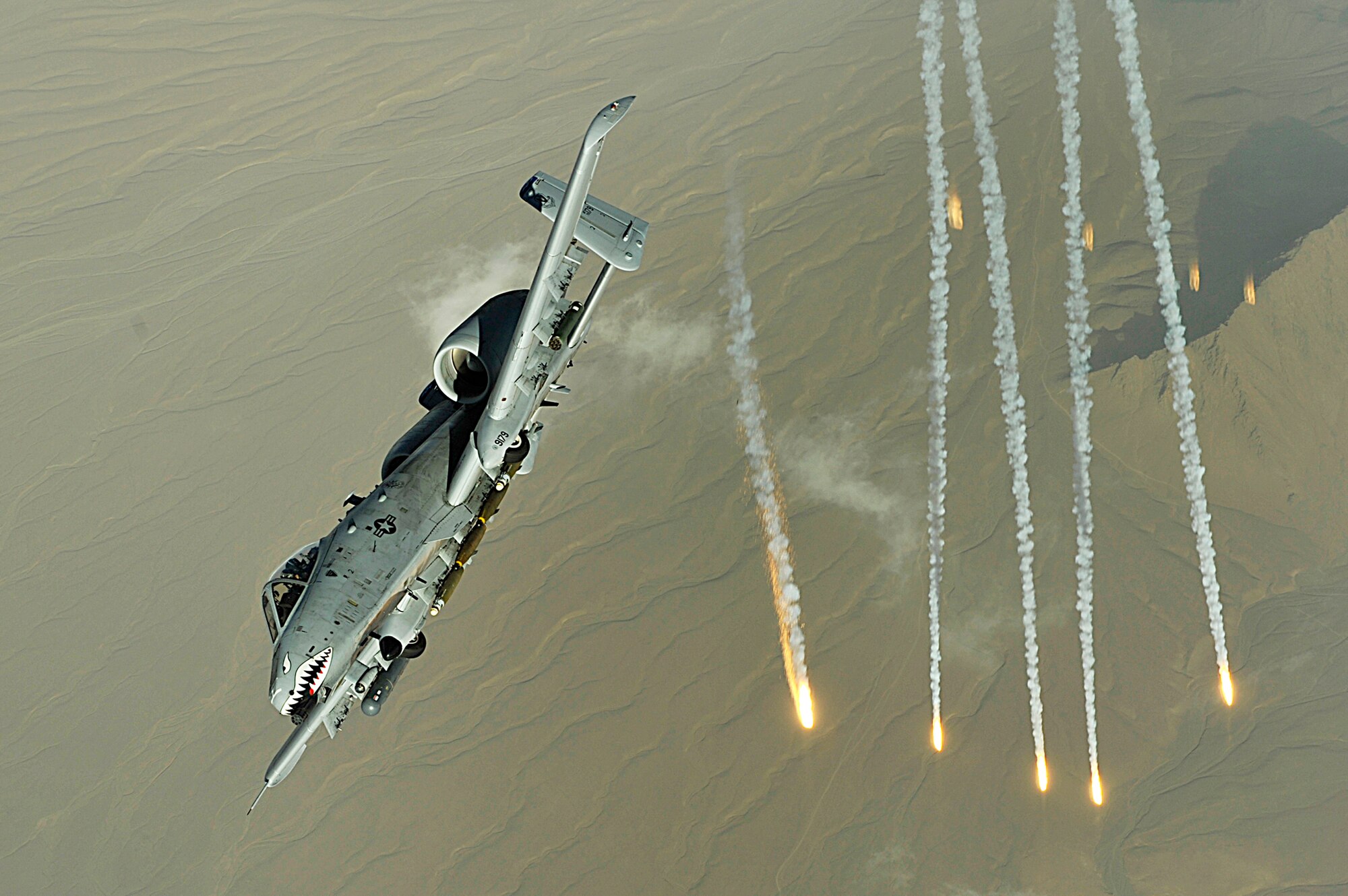 An A-10 Thunderbolt II deploys flairs over Afghanistan Nov. 12, 2008. A-10s provide close-air support to ground troops in Afghanistan and Iraq. The A-10's excellent maneuverability at low air speeds and altitude and its highly accurate weapons delivery make it an ideal aircraft for supporting coalition operations.
(U.S. Air Force/photo by Staff Sgt. Aaron Allmon)  
