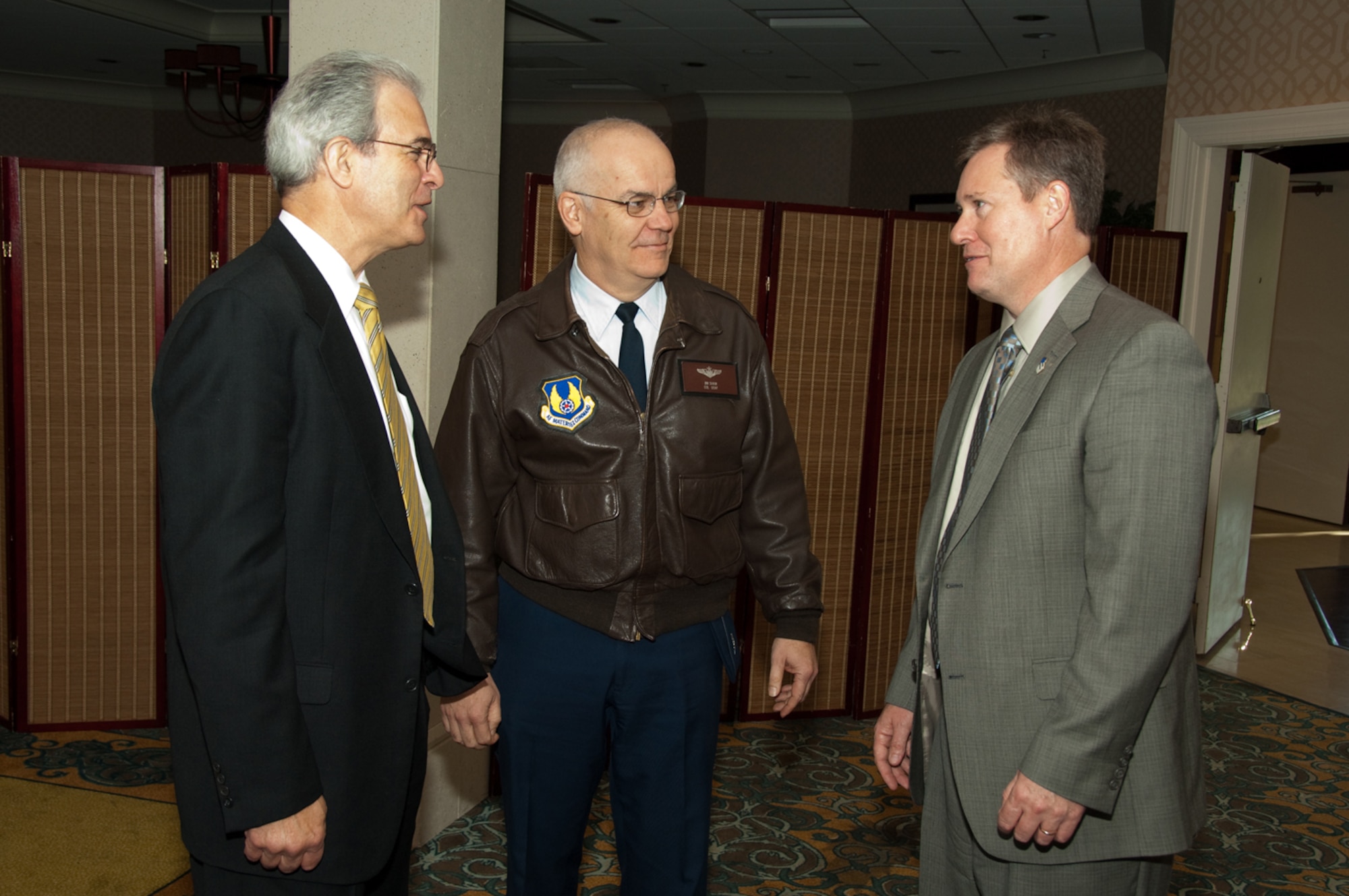 Patrick Dagle, the acting director of 751st Electronic Systems Group (right), chats with former Joint STARS’ group director David LaRochelle and Col. James Shaw, commander of the 851st ELSG, during the Military Affairs Council breakfast Oct. 14.  (Photo by Rick Berry)