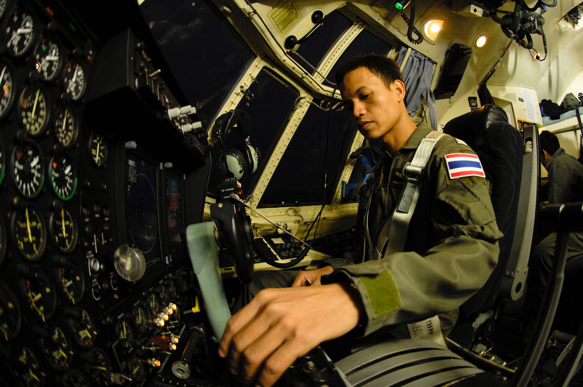ELMENDORF AIR FORCE BASE, Alaska -- Royal Thai air force Maj. Prakorb Khumtho, 601st Airlift Squadron leader and director of operations, prepares himself for takeoff Oct. 15  during Red Flag-Alaska 10-01. This is the fourth RF-Alaska exercise the Royal Thai air force has participated in. The first year of participation was in 2003. By participating in RF-Alaska, Thailand continues a close diplomatic relationship with the U.S. which goes back 176 years making Thailand one of the longest allies the U.S. has had. (U.S. Air Force photo/Airman 1st Class Christopher Gross)