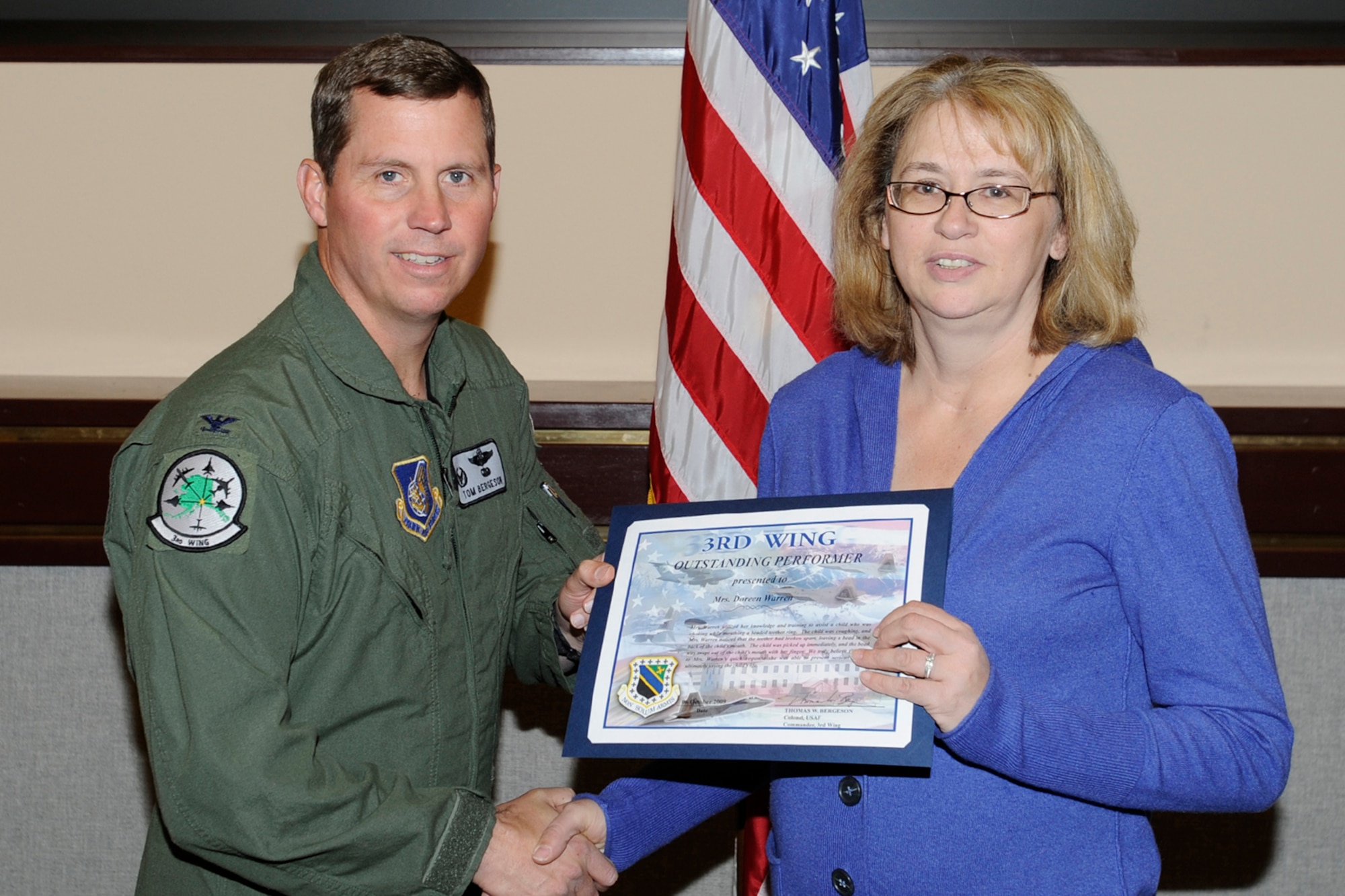 ELMENDORF AIR FORCE BASE, Alaska -- Doreen Warren receives an outstanding performer certificate from Col. Thomas Bergeson, 3rd Wing commander, Oct. 6. (U.S. Air Force photo/Senior Airman Matt Coleman-Foster)