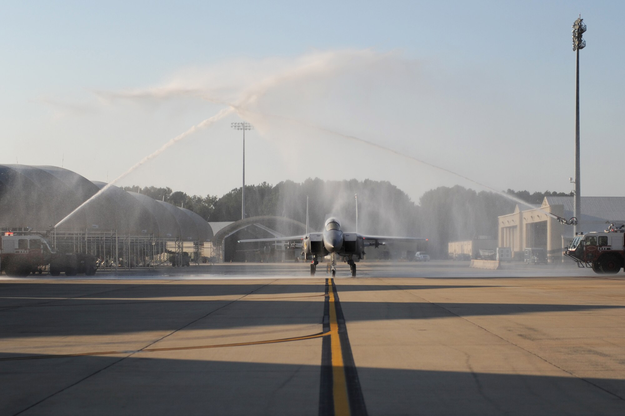 Col. Mark Kelly, 4th Fighter Wing commander, and Maj. James Crider, 4th Aeromedical Dental Squadron flight medicine primary care physician, taxi under fire truck spray at Seymour Johnson Air Force Base, N.C., Oct. 9, 2009.  Colonel Kelly has logged more than 5,000 flight hours during his military career, 3,000 of those in the F-15E Strike Eagle. (U.S. Air Force photo/Airman 1st Class Rae Perry)