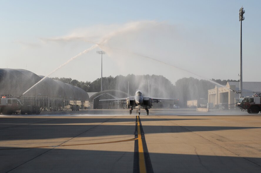 Col. Mark Kelly, 4th Fighter Wing commander, and Maj. James Crider, 4th Aeromedical Dental Squadron flight medicine primary care physician, taxi under fire truck spray at Seymour Johnson Air Force Base, N.C., Oct. 9, 2009.  Colonel Kelly has logged more than 5,000 flight hours during his military career, 3,000 of those in the F-15E Strike Eagle. (U.S. Air Force photo/Airman 1st Class Rae Perry)