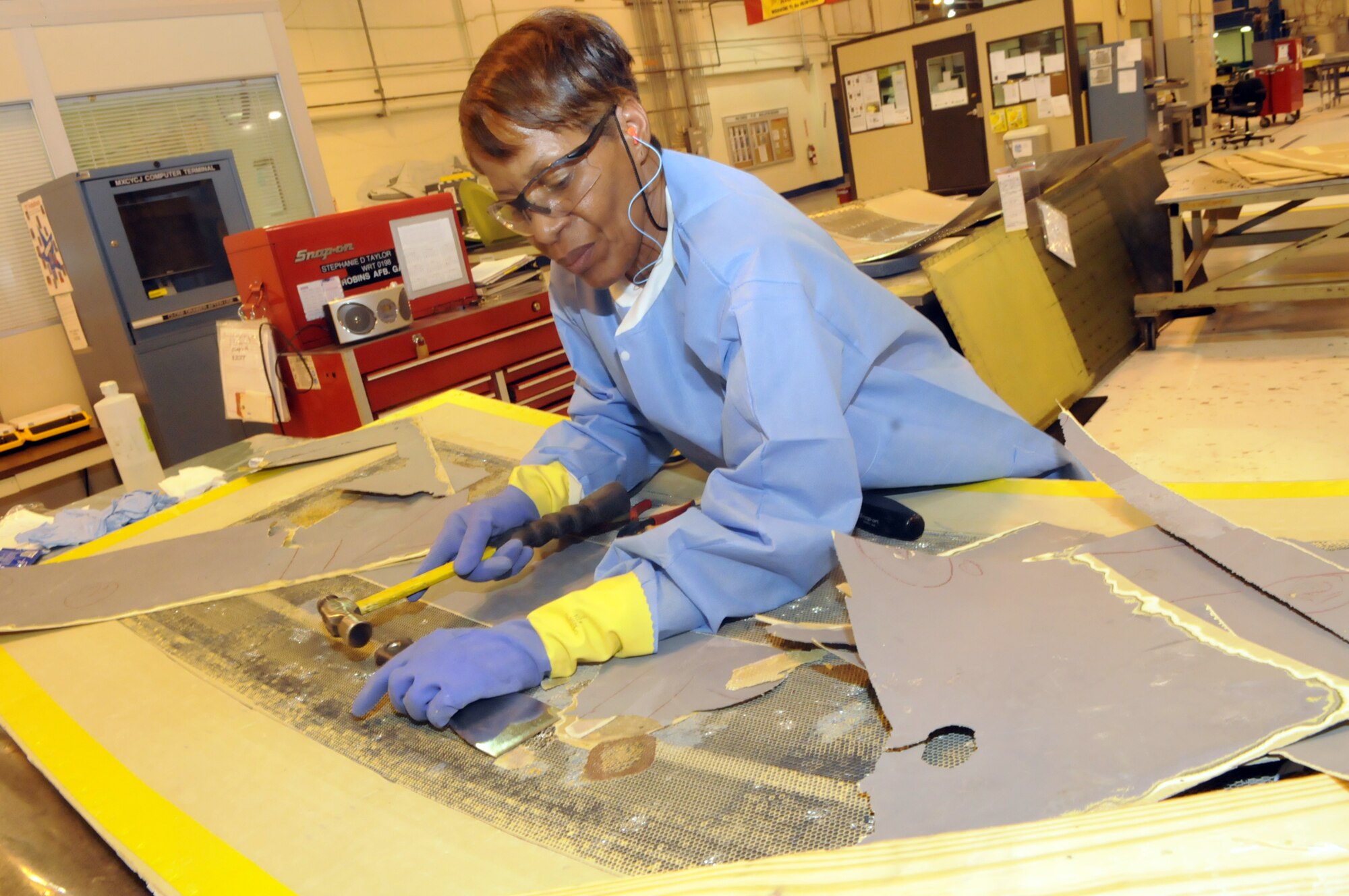 Stephanie Taylor tears down a C-5 panel for repair. U. S. Air Force photo by Sue Sapp