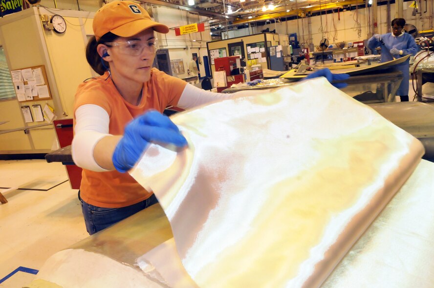 Pamela White puts fiberglass on a composite panel for repair. U. S. Air Force photo by Sue Sapp