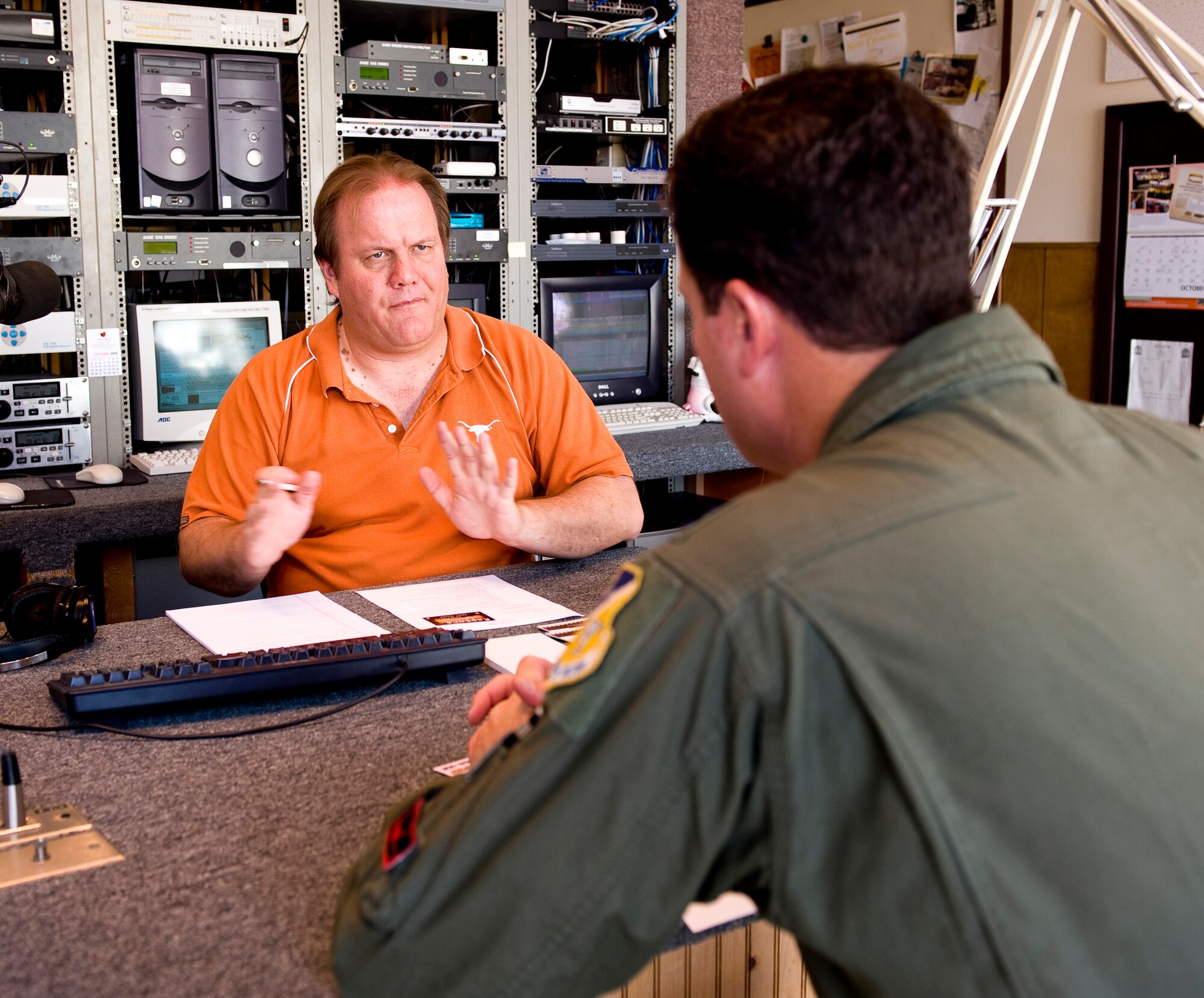 ARTESIA, N.M. -- Capt. August Pfluger, 49th Fighter Wing Open House director, speaks with Mike Jaxson during a radio show here about the upcoming Open House "Raptors and Reapers over the Southwest," scheduled for Oct. 24 at Holloman Air Force Base, N.M. Captain Pfluger said this Open House will be the "most unique" open house with three international air forces performing - Canadian, German and U.S. (U.S. Air Force photograph by Tech. Sgt. Alan Port)