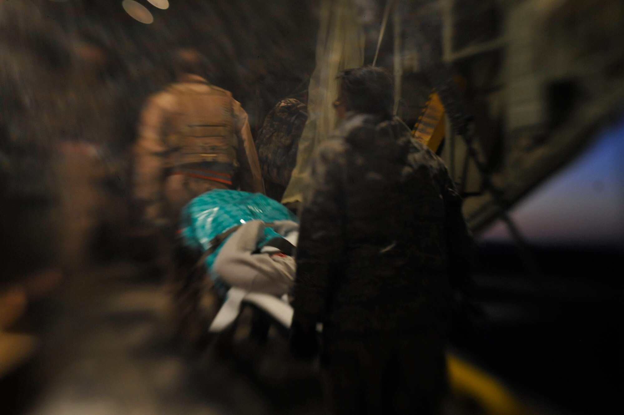 Airmen from the 451st Aeromedical Evacuation Squadron transport an Afghan patient into an HC-130 Hercules at Camp Bastion Oct. 6, 2009. (U.S. Air Force photo/Staff Sgt. Angelita Lawrence) (U.S. Air Force photo/Staff Sgt. Angelita Lawrence)