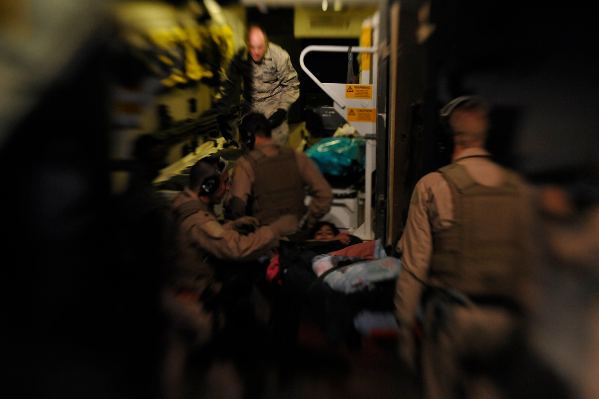 Airmen from the 451st Aeromedical Evacuation Squadron transport an Afghan patient to a higher level of care at Camp Bastion Oct. 6, 2009. The U.S. Air Force provides care to patients from the U.S., coalition partners and locals on a daily basis.(U.S. Air Force photo/Staff Sgt. Angelita Lawrence)