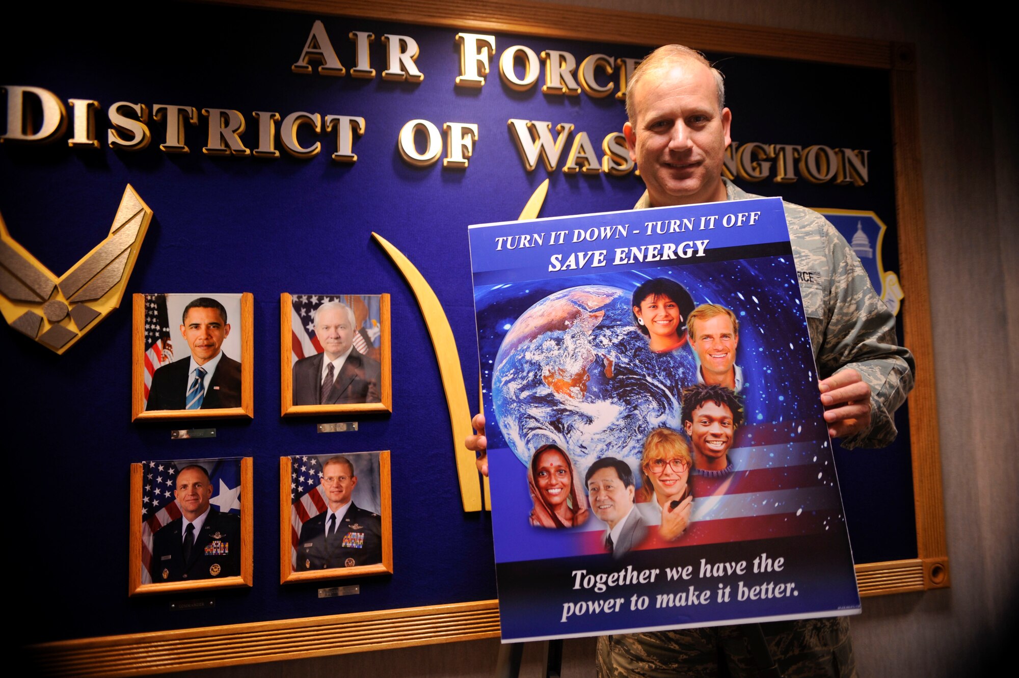 Air Force District of Washington Command Chief Master Sergeant, Pat Battenberg, reveals this year?s new energy conservation poster.  (U.S. Air Force photo/Senior Airman Steven R. Doty)