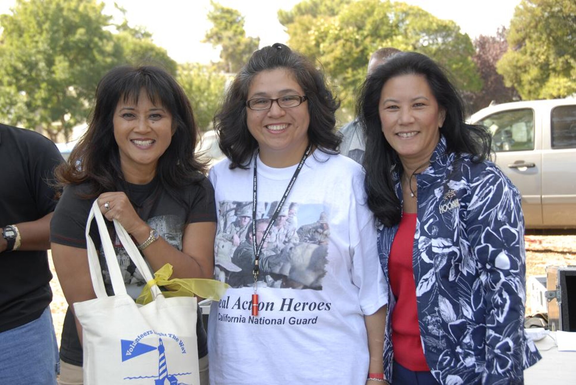 Leslie Wade (right), wife of Maj. Gen. William H. Wade, the California Adjutant General, and Carolann Wunderlin (left), the 129th Rescue Wing Family Readiness Program coordinator, present a gift to Elaine Vindiola, 129th Mission Support Group Spouse of the Year award winner Oct. 4 at the annual Family Day Picnic at Moffett Federal Airfield, Calif. (Air National Guard photo by Tech. Sgt. Ray Aquino)