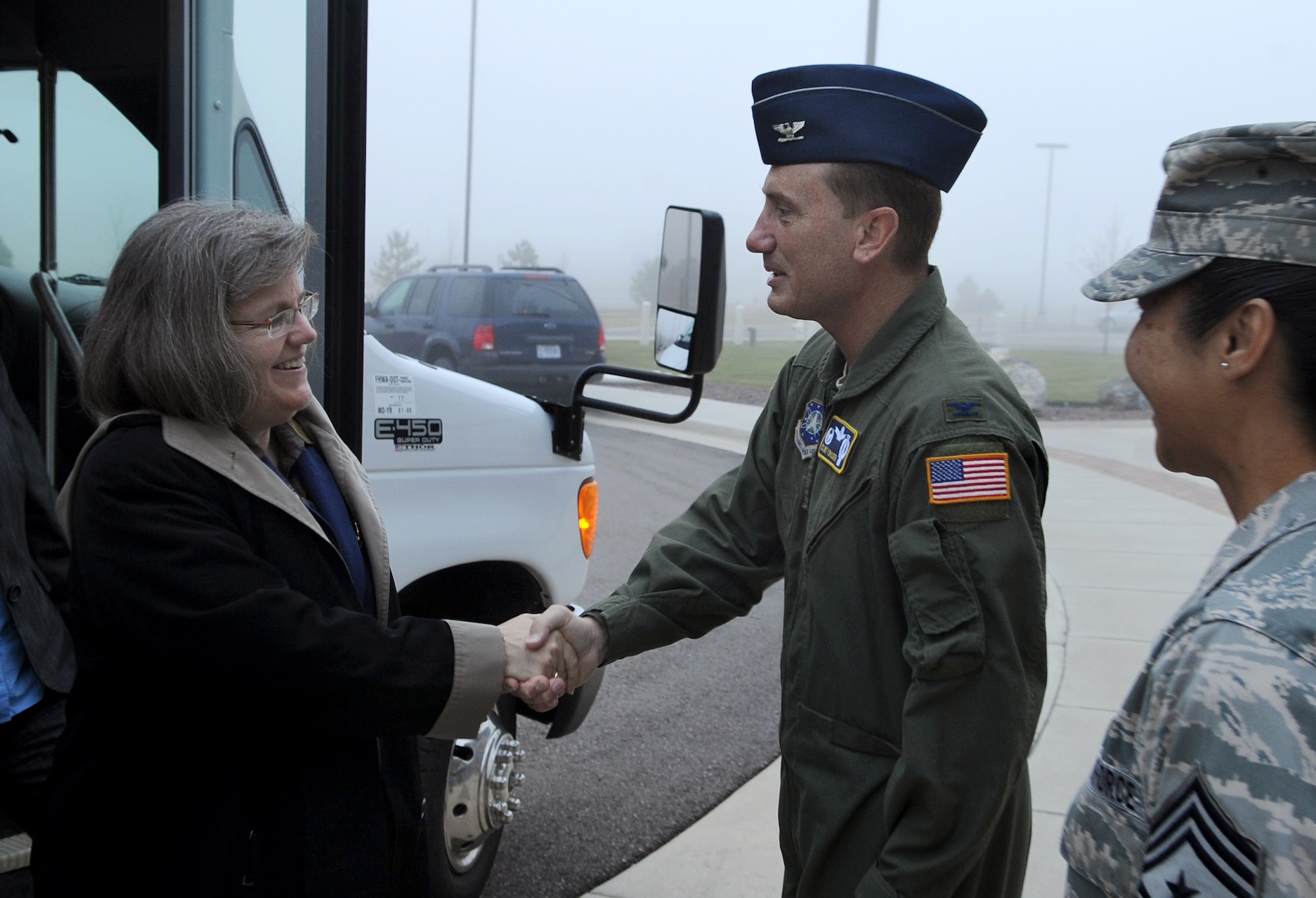 Col. Clint Crosier, 460th Space Wing Commander, welcomes Better Business Bureau's Military Line director, Mrs. Holly Petraeus to Buckley Air Force Base, Colo. on Oct. 14. The Better Business Bureau's Military Line is an affiliate of the Department of Defense Financial Readiness campaign and offers free services and consumer education to military members. (U.S. Air Force photo by Senior Airman Erika Brooke) 