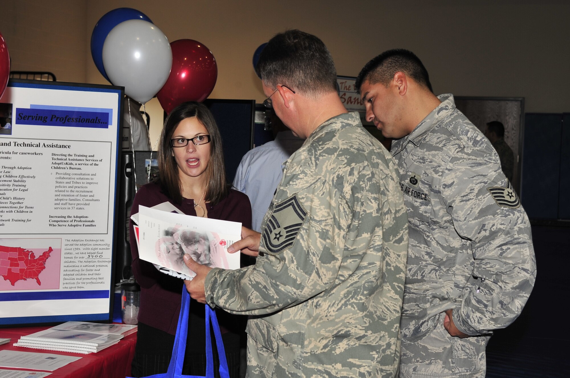 Buckley Air Force Base, Colo.-- 460th Force Support Squadron's Senior Master Sgt. Mark Baxter and Tech. Sgt. Ron Cervera receive information and brochures about the Combined Federal Campaign during the kick-off ceremony, Oct. 14, 2009. The CFC is a way for federal employees to come together and contribute to local and global charities. (U.S. Air Force photo by Airman 1st Class Manisha Vasquez)