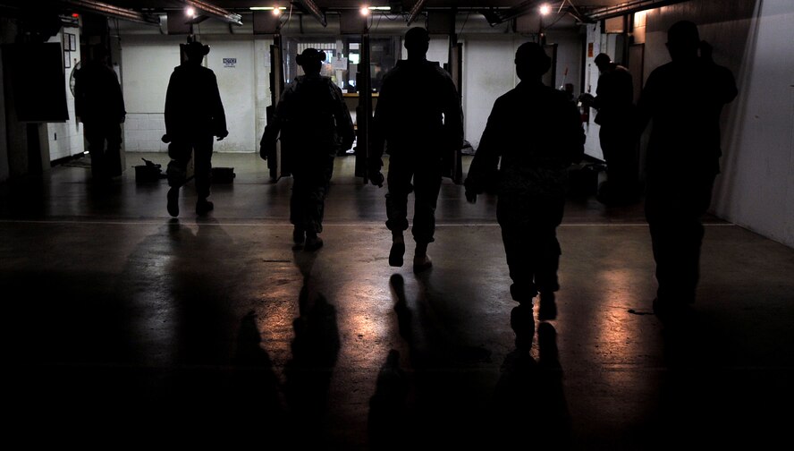 Members of the 11th Security Forces Squadron head back to their stations after having their targets reviewed by the range instructors Sept. 14 at the Anacostia Armory/Range on Anacostia. What used to be a firing range for only U.S. Navy members, now houses both the Navy and the Air Force. With joint basing rapidly approaching, the 11th Security Forces Squadron and the members at the Anacostia Armory/Range have already made the transition. (U.S. Air Force photo by Senior Airman Marleah Miller) 
