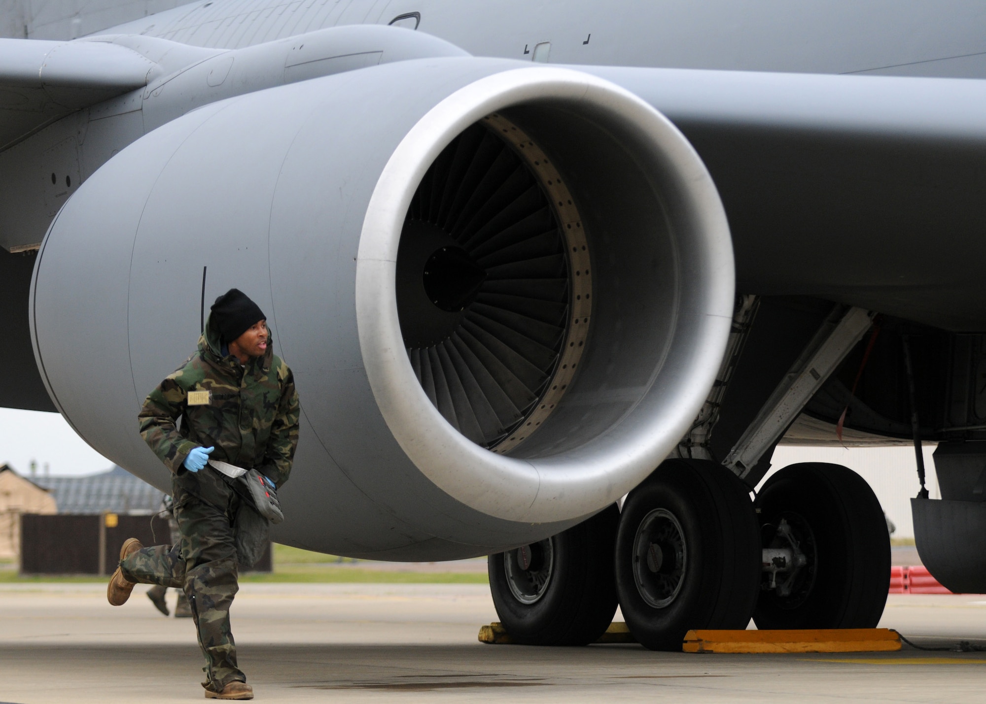 RAF MILDENHALL, England – Staff Sgt. Charles Douglas, 100th Aircraft Maintenance Squadron crew chief, sprints to notify surrounding personnel about a simulated fuel spill during the Operational Readiness Inspection Oct. 14. The ORI scenario tested the Airmen’s ability to effectively and safely react in an emergency situation. (U.S. Air Force photo/ Staff Sgt. Jerry Fleshman)
